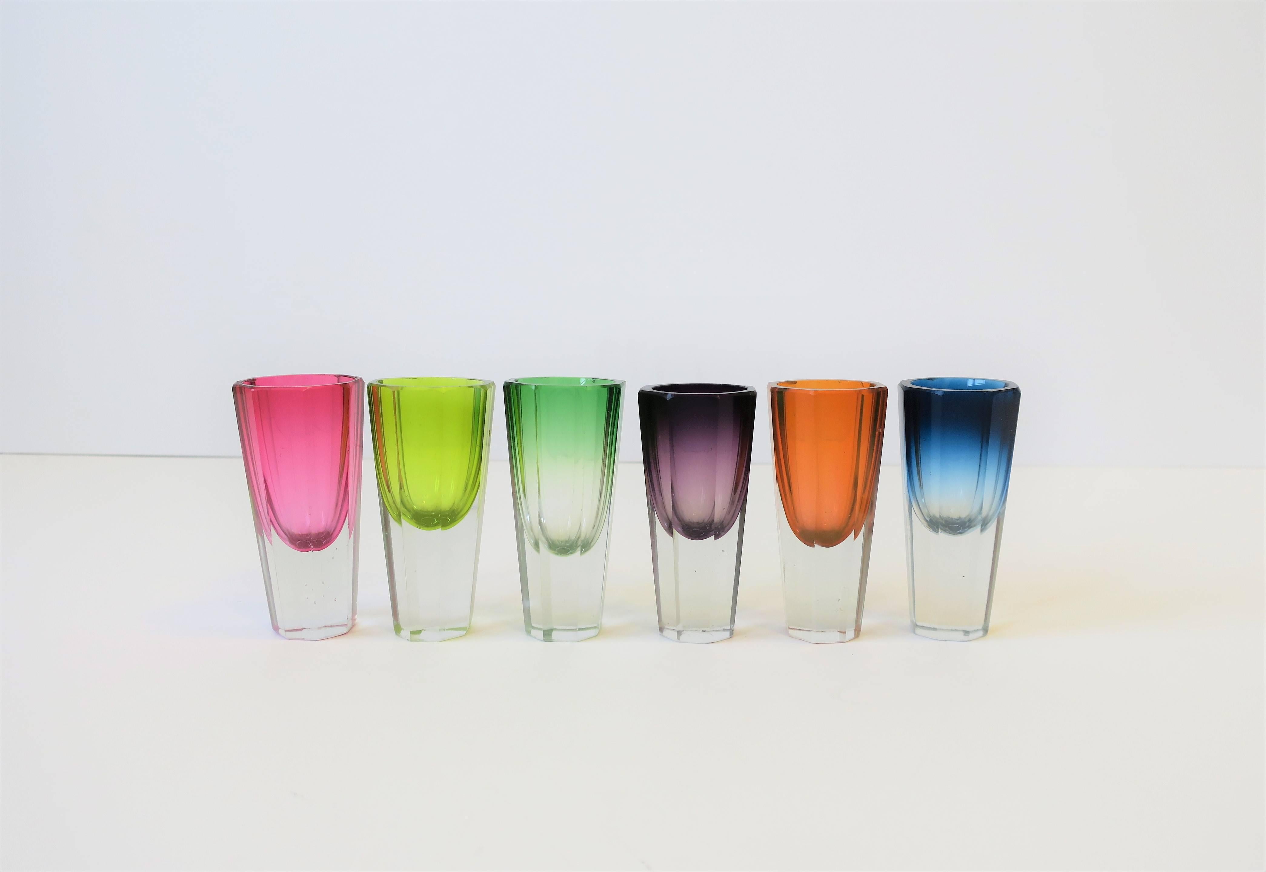 A very beautiful set of six (6) European Czech Bohemian clear and colorful octagonal crystal liquor or spirit shot glasses in a rainbow of colors, circa mid-20th century, Europe. These six (6) crystal shot glass, cut in an octagonal shape, are held
