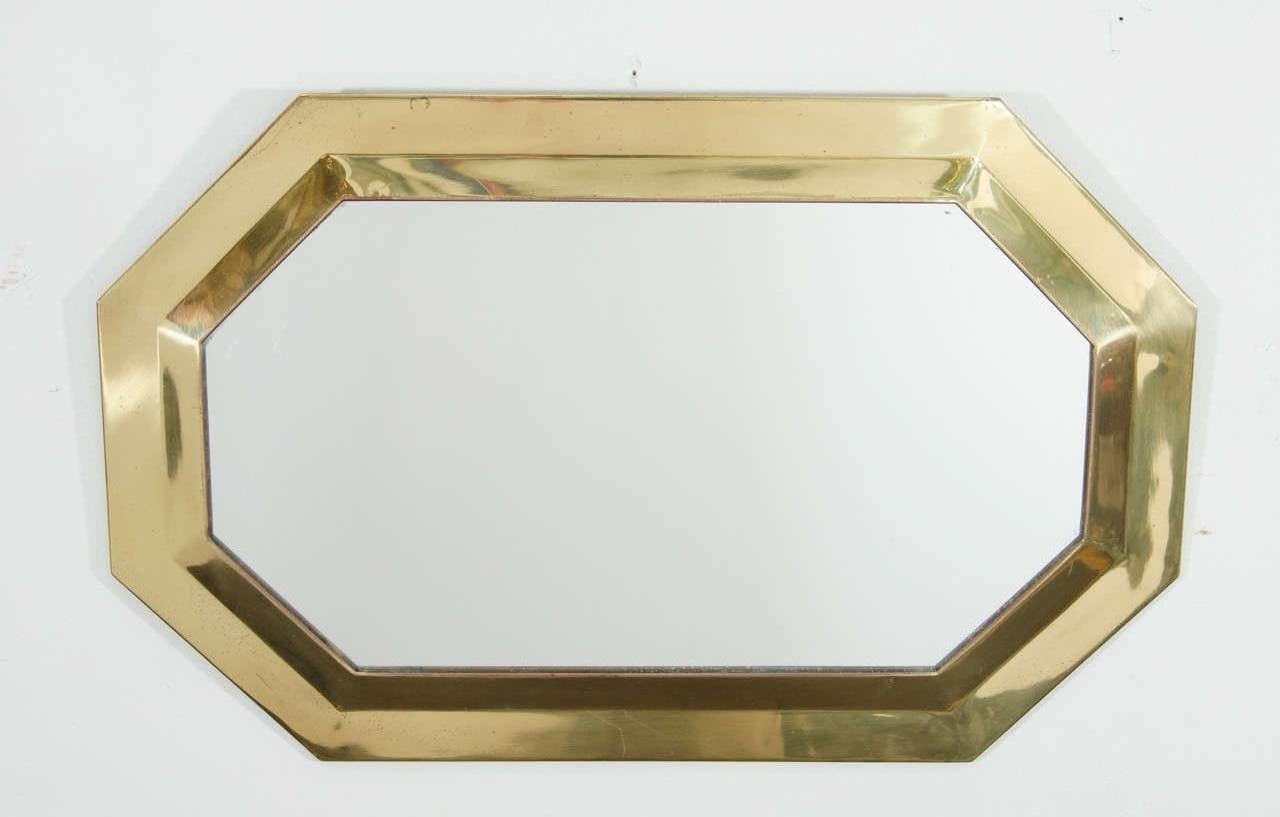 A small brass octagonal framed wall mirror, circa 1970s. Mirror is prepared to hang horizontally or vertically. 

Vertically, image #1, 12.5 in W x 19.5 in H. 
Horizontally, as show in image #2, measures: 19.5 in. W x 12.5 in. H.


 