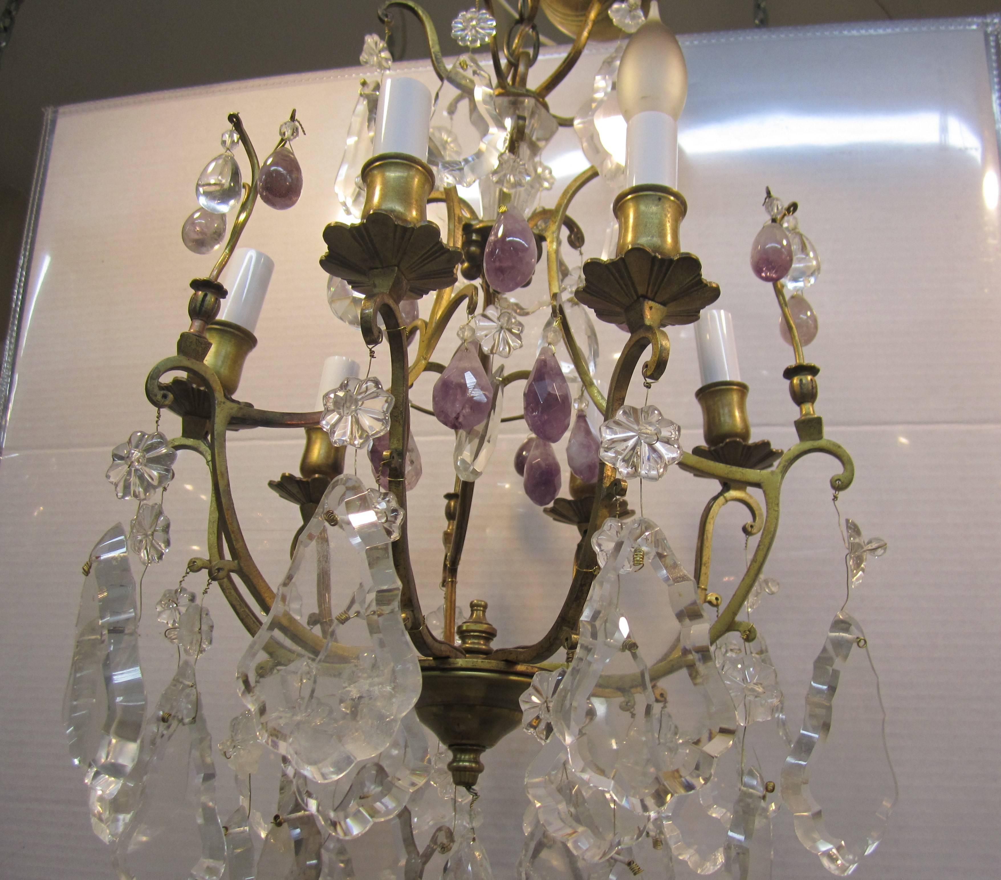 A beautiful six-arm (light) gold gilt bronze chandelier with clear crystals and honed purple amethyst crystals. Largest crystal is 6