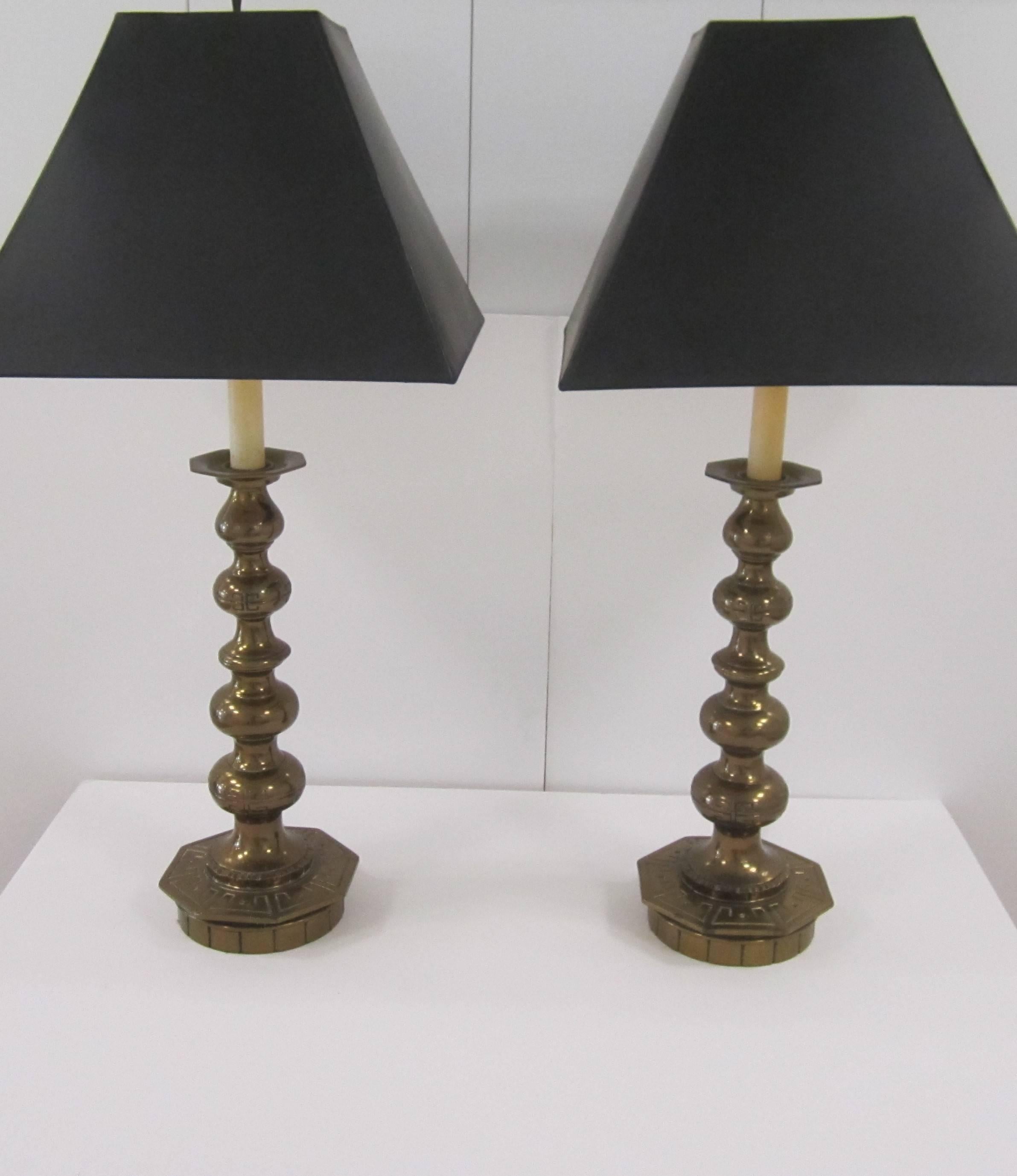A beautiful and striking pair of tall vintage gold or brass colored table lamps with octagonal base and embossed Greek key design, circa 1960s-1970s. Measures 24 inches H to top of finial. Pair available here online. By request, pair can be made
