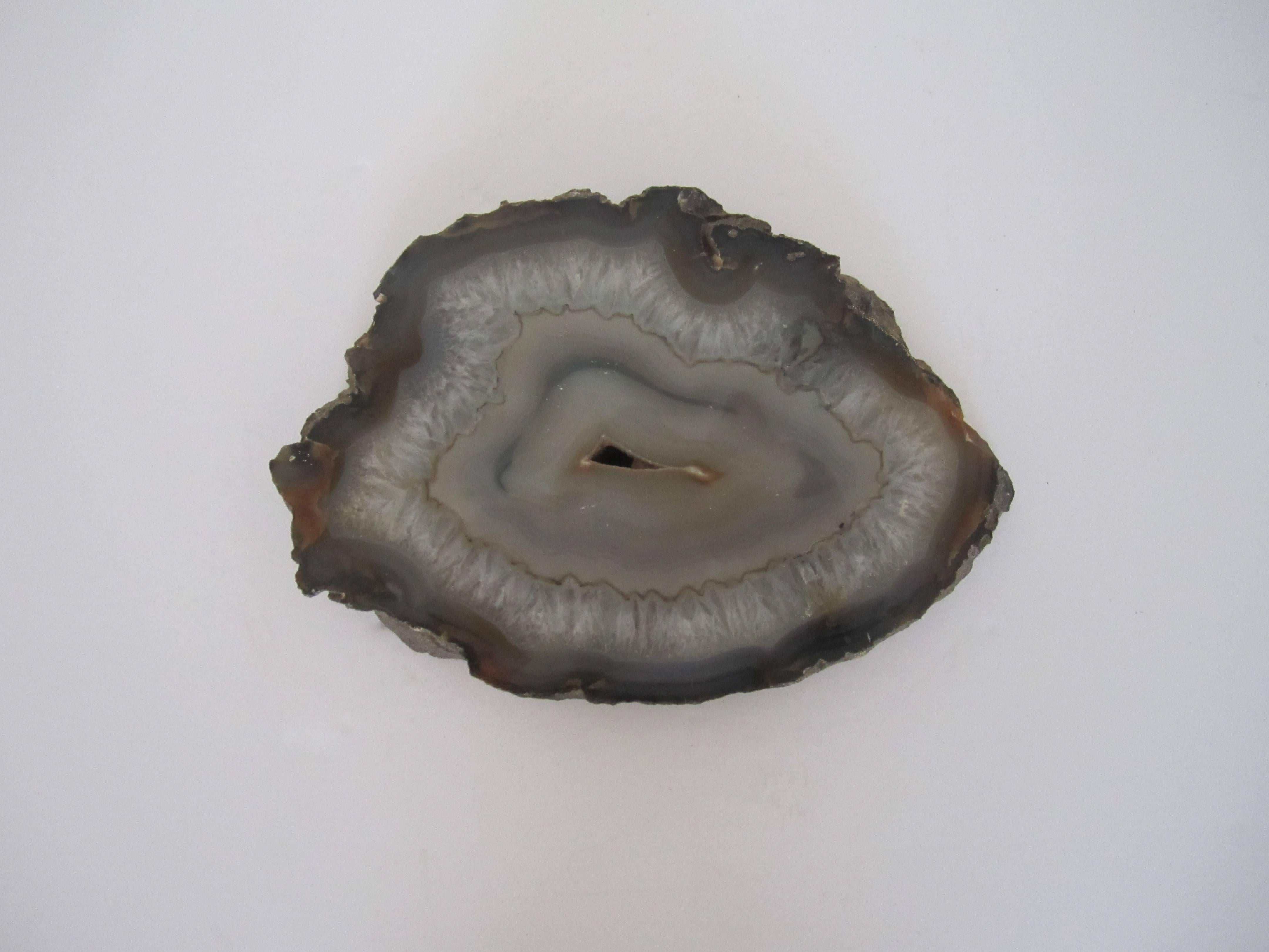 A substantial polished natural agate/geode/onyx decorative object in shades of grey and white. Piece can be used as a decorative piece for a shelf, table, desk, etc., or as a display piece, etc. Measures 7.5
