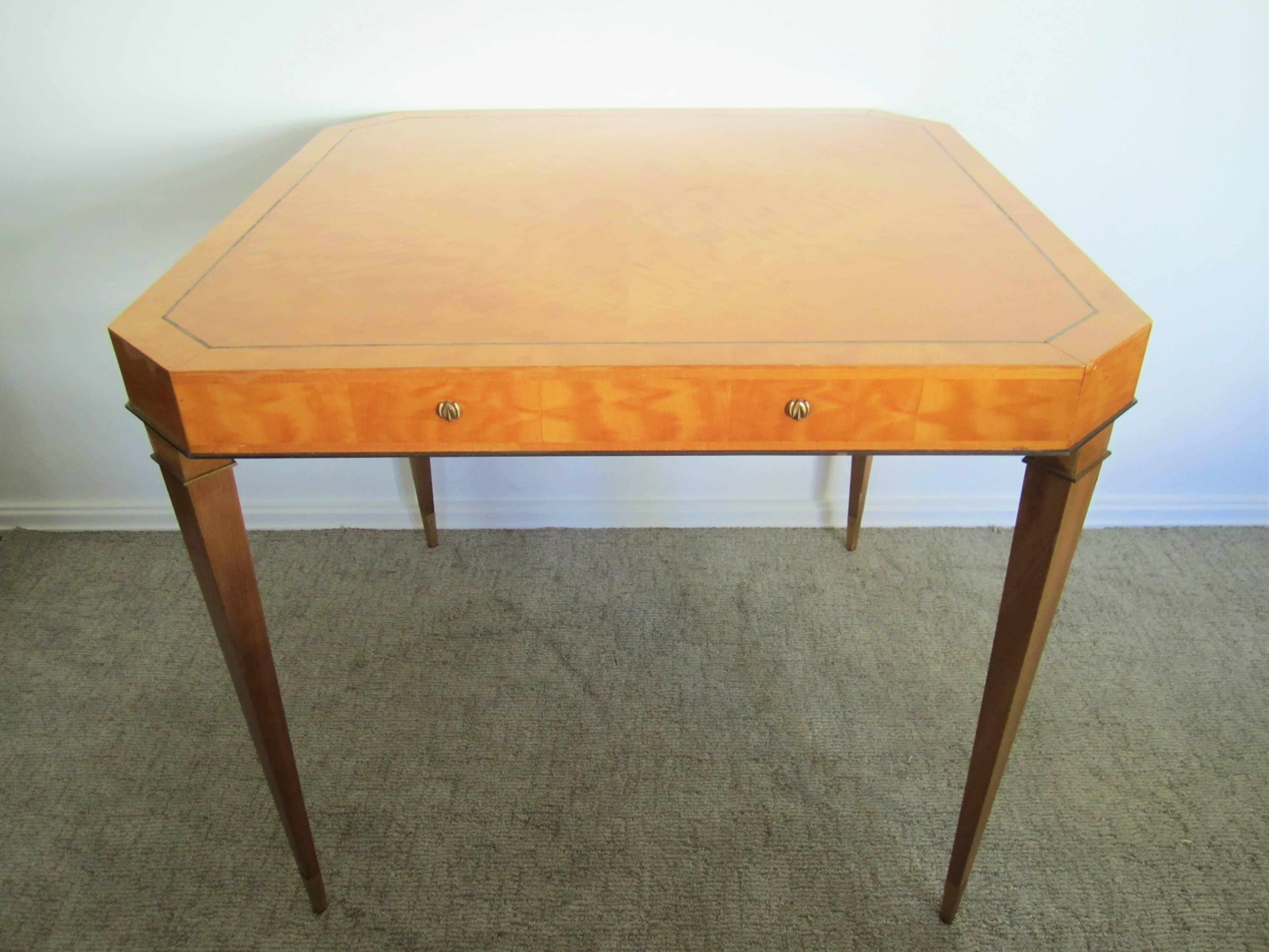 An elegant Italian Modern Art Deco game, foyer, or center table, of birds-eye maple wood, brass detailing, and beautiful design. 

Item available here online. By request, item can be made available by appointment to the Trade in New York.