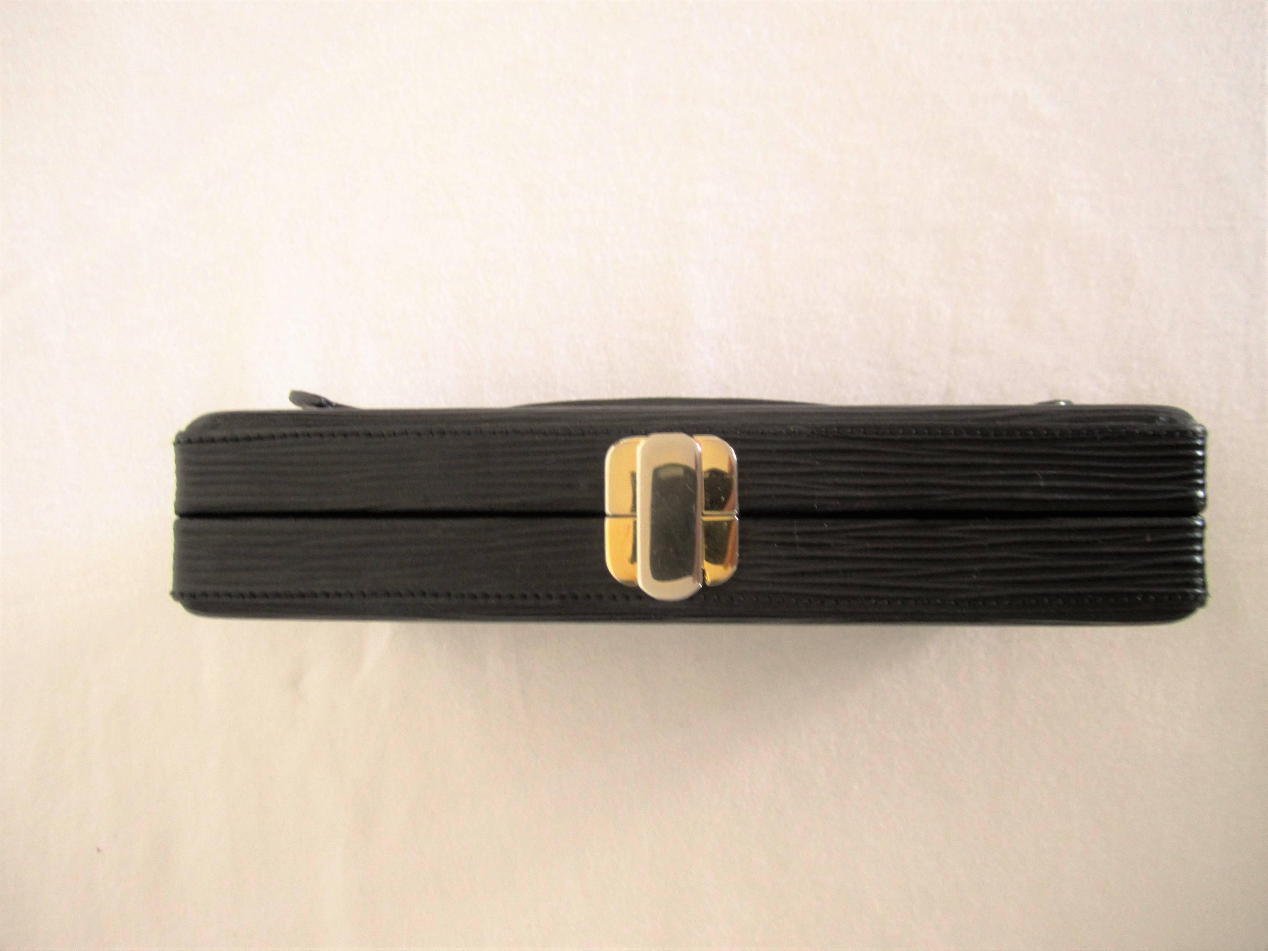 A vintage black Fendi rectangular clutch bag / handbag from Italy. Black epi leather. Great interior detail as show in images. Gold-tone metal FENDI authentication mark inside as shown in image. Comes with FENDI dust bag. Elegant and easy to carry.