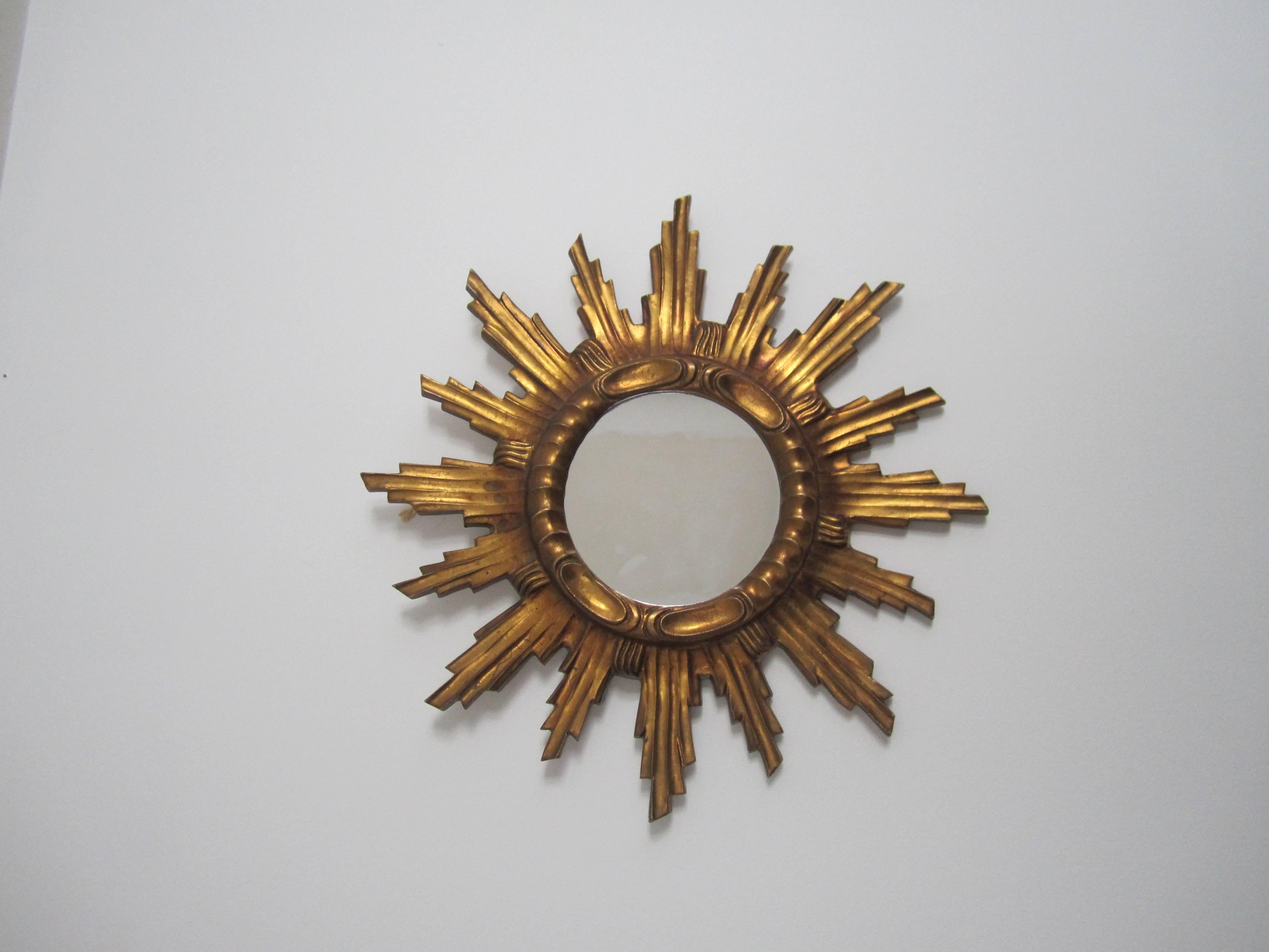 A vintage sunburst giltwood mirror, France, circa 1950s. Item available here online and by request, can be made available by appointment to the Trade (in New York.) Measurements: Entire mirror is 21