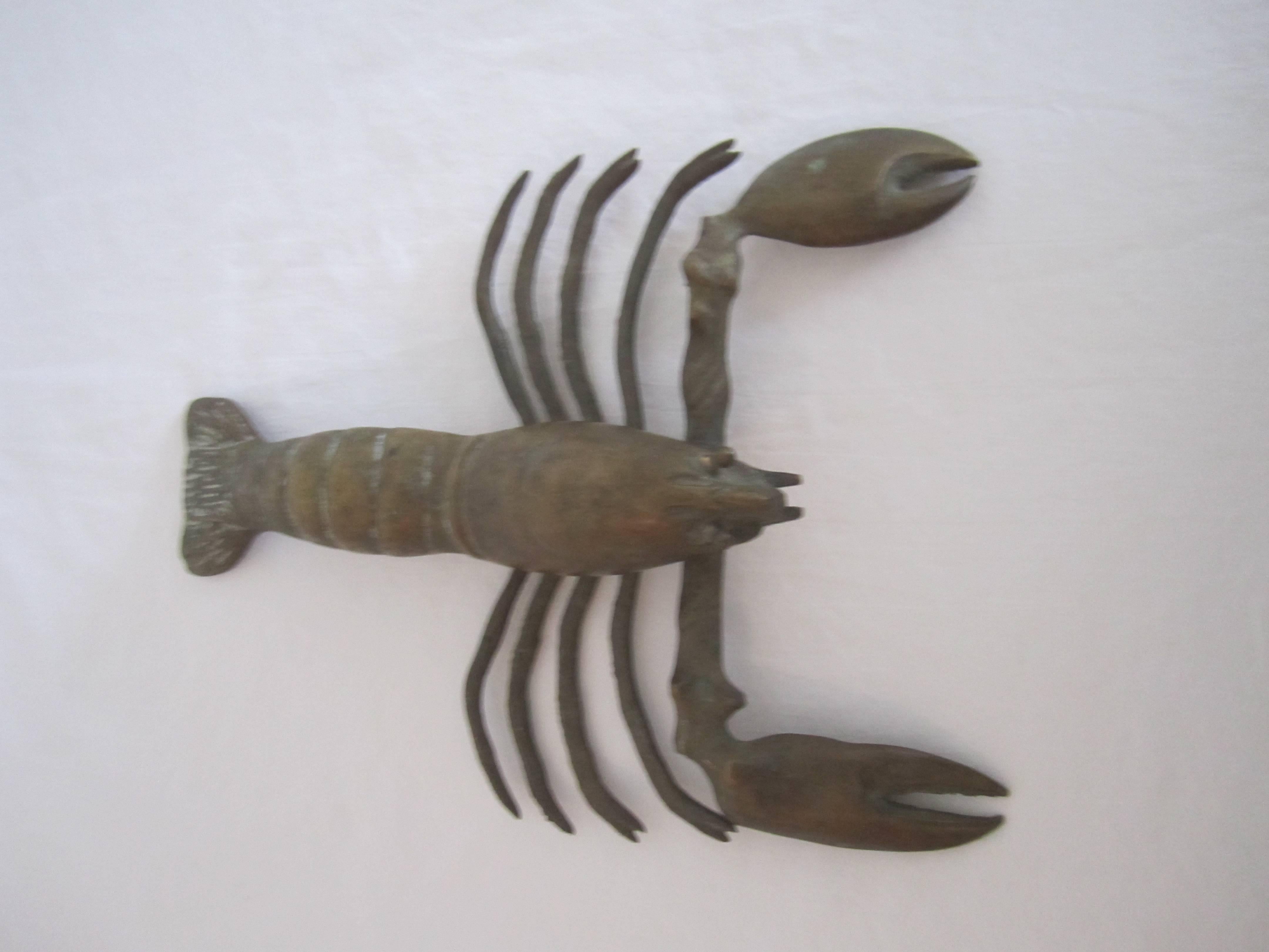 Vintage solid brass Lobster sculpture with desirable patina. 

Lobster measures 9.5 in. Long x 7.5 in. W x 2.5 in. H. 

Item available here online. By request, item can be made available by appointment to the Trade in New York.