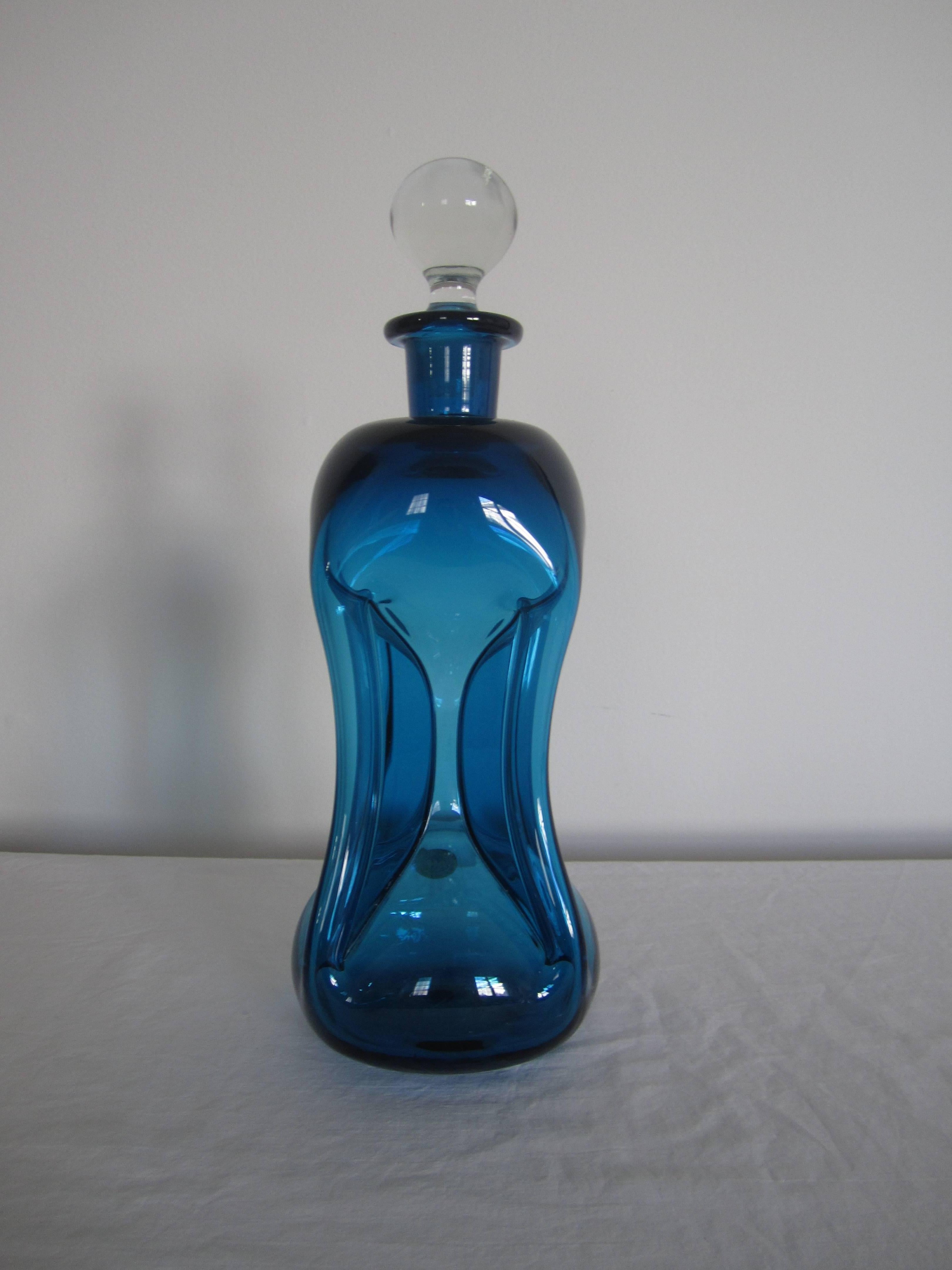A vintage Scandinavian modern blue pinched art glass spirits bottle or decanter by HOLMEGAARD, Denmark. With makers mark label. Item available here online, and by request, can be made available at my showcase space in the Showplace Antique + Design