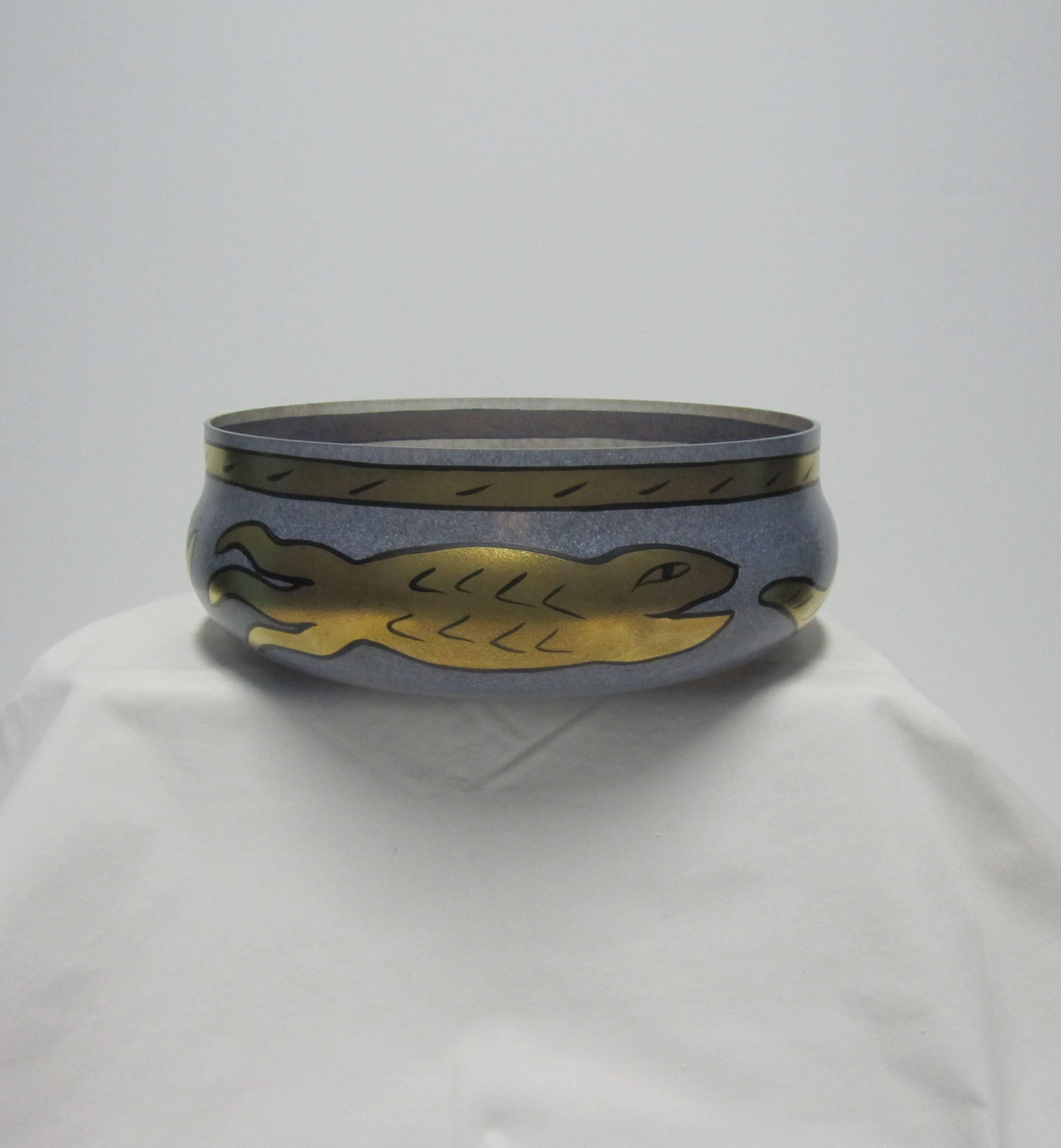 A beautiful glass centerpiece bowl in blue, black and gold, with serpent snake or fish design, hand-painted and signed by artist Ulrica Hydman-Vallien for Kosta Boda. Made in Sweden, circa 1990s. Maker's mark see image #7, and artist signature see