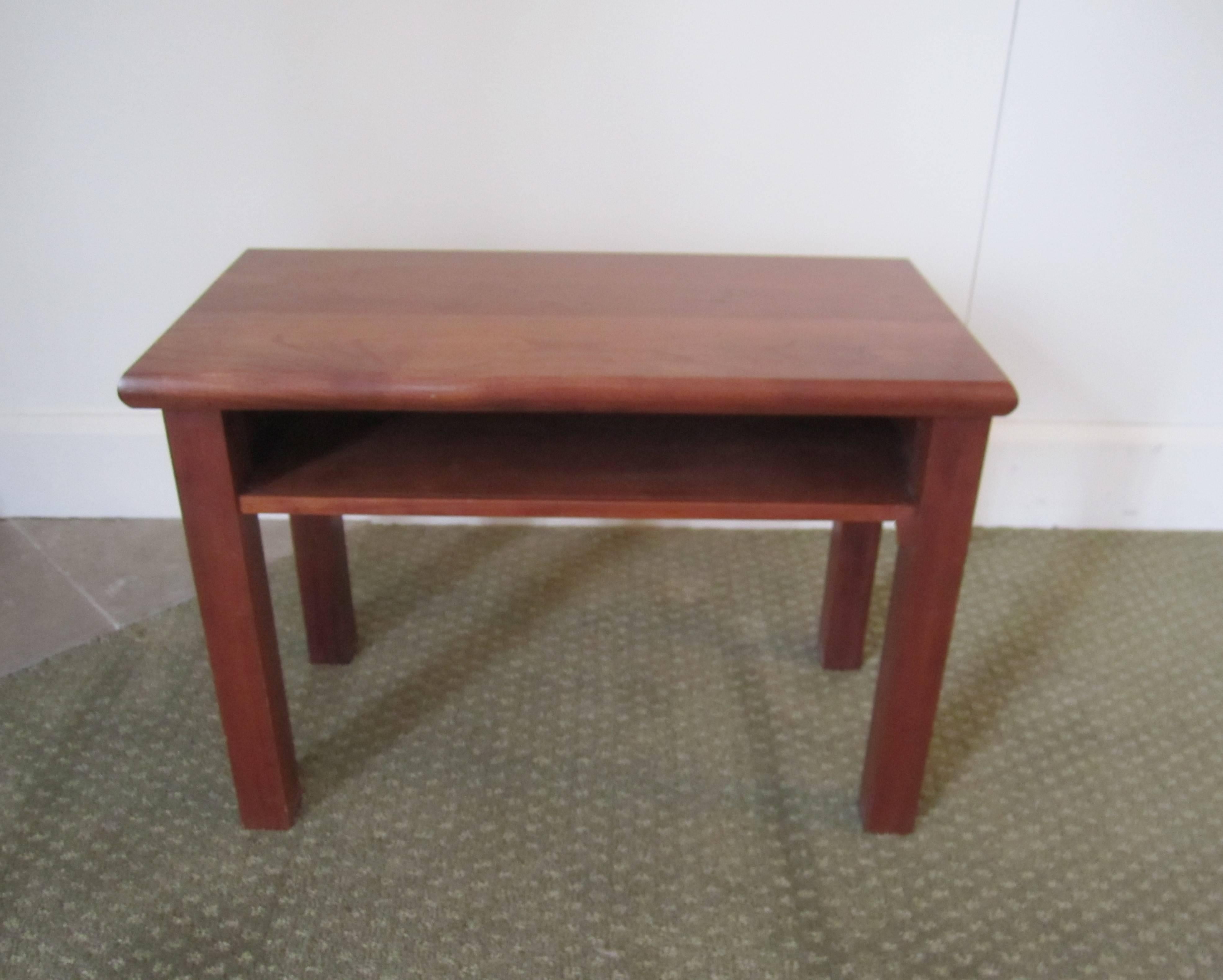 A small rectangular vintage wood end or side table with shelf. Convenient size with a shelf that may hold a book, magazine, etc. 