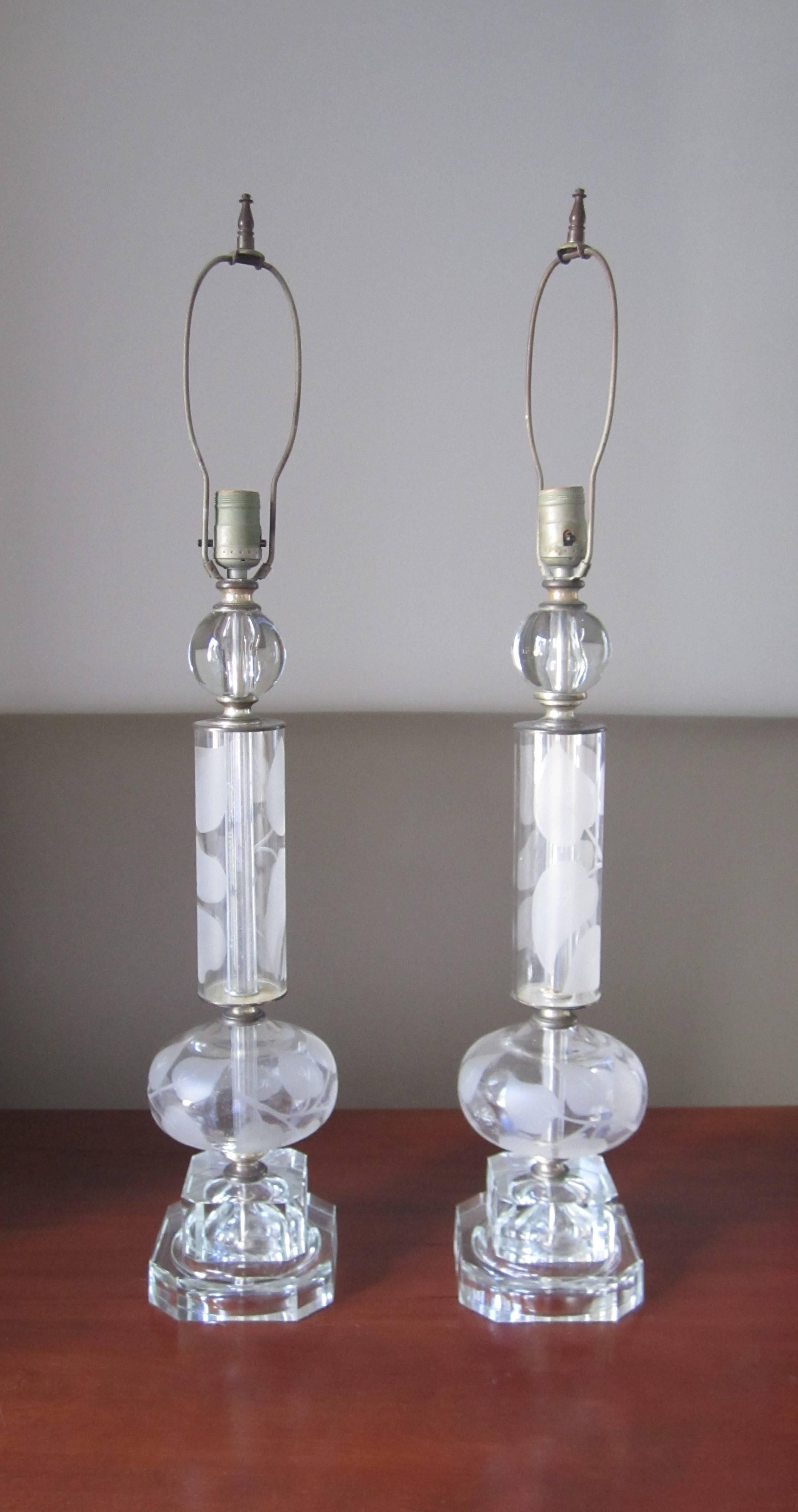 A substantial and very beautiful pair of clear crystal table lamps in the Art Nouveau style, early to mid-20th century, circa 1940s, Europe. Pair have an etched leaf design, crystal ball at top, finished with square bases with tapered corners. Bases