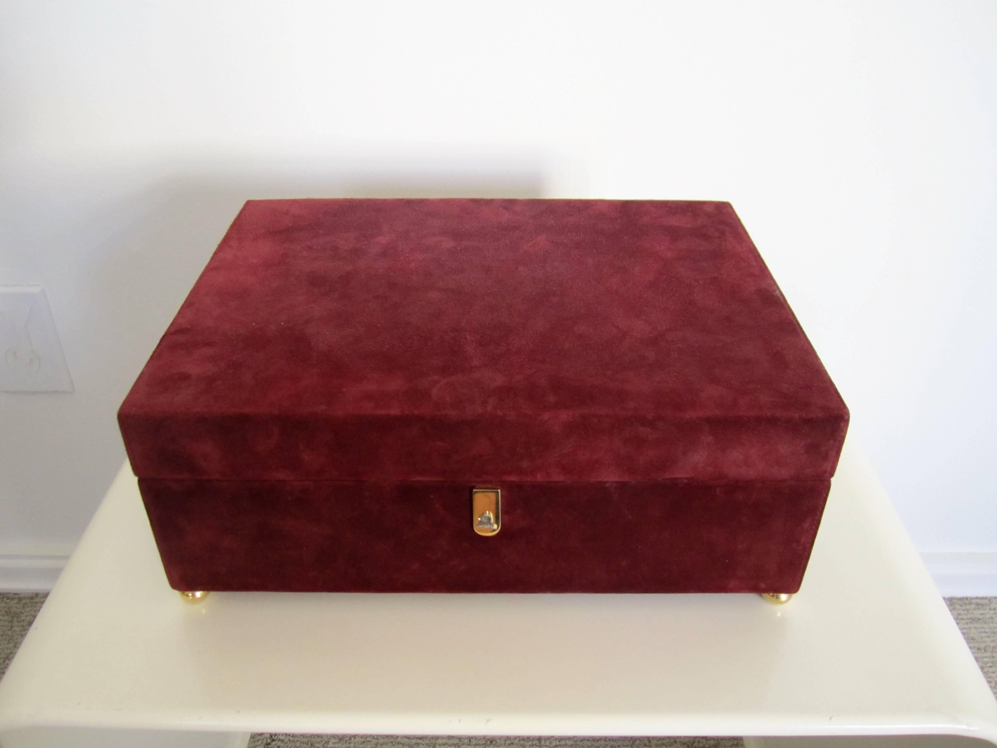 Made in Italy, a beautiful burgundy suede and leather hinged jewelry box with lock and key by designer Mark Cross. Box interior is a beige suede. Exterior is burgundy suede and leather. Tray is removable and allows for storage underneath. Maker's