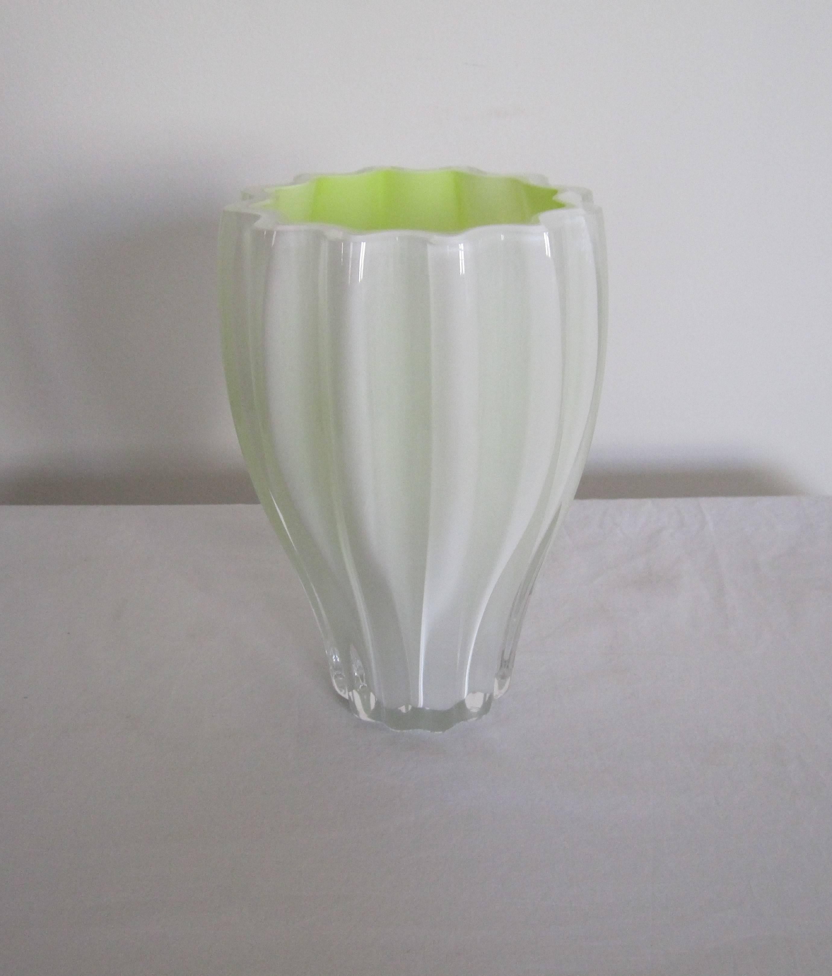 A beautiful Scandinavian Postmodern white and neon/florescent yellow art glass fluted vase from Kosta Boda, Sweden. Vase is numbered, 40015, and signed by artist designer on bottom as show in image #8. Beautiful with or without flowers. Very good