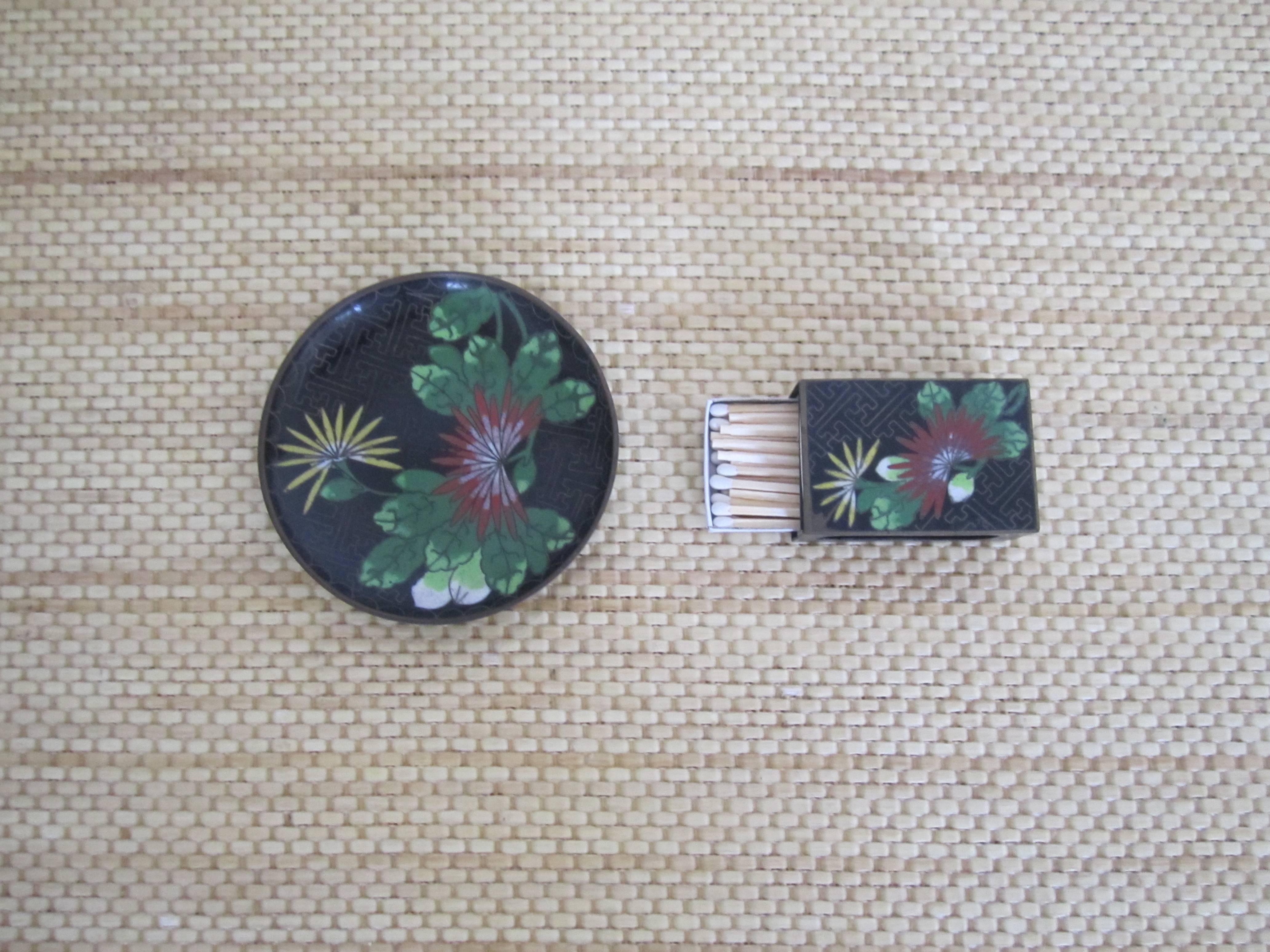 An enamel Chinese Cloisonné match box case set, circa early-20th century. Set includes 1 matchbox holder, and 1 dish/plate (for used matches, ashes.) This beautiful set is made of black, emerald green, light green, yellow, red and white enamel, in