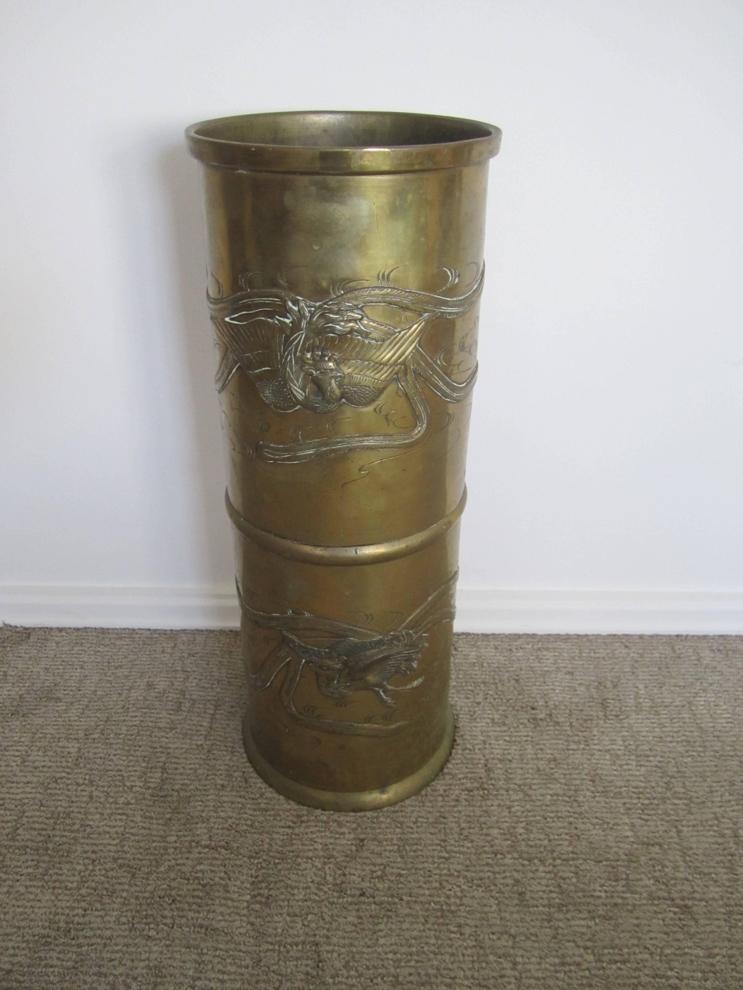 A substantial Late 19th Century early 20th Century Chinese brass umbrella stand or vessel with embossed decorative 'flying Crain's'. Item available here online, and by request, can be made available at the Showplace Antique + Design Center, 3rd