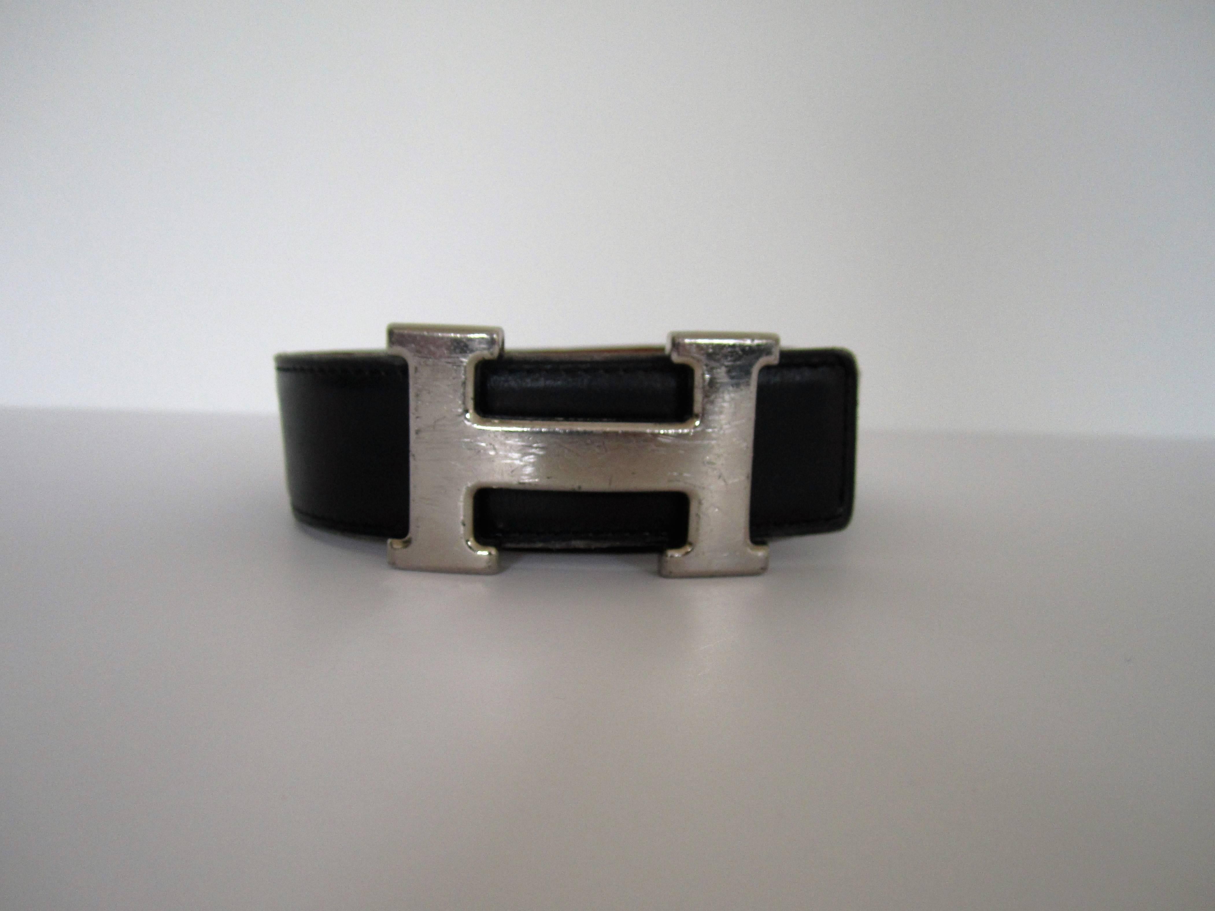 A classic Hermès Black / Tan (reversible) leather belt with iconic 'Constance' 'H' palladium metal removable belt buckle, with tonal stitching on leather belt. Maker's mark (HERMES) and marked 'made in France'. Belt (Waist) size 80 cm. Belt