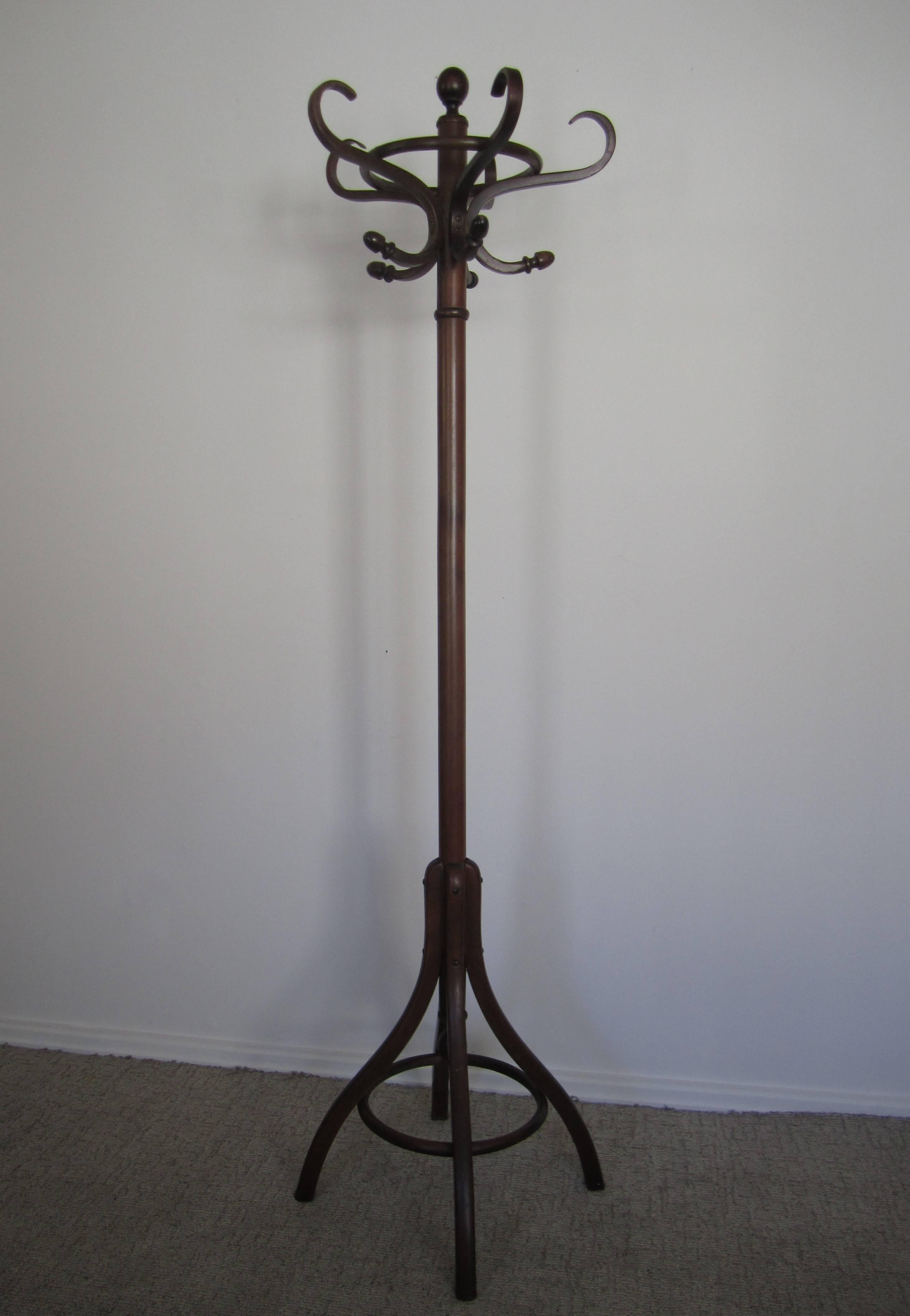 A beautiful vintage bentwood coat tree or hall rack attributed to Thonet. Coat stand has a ring base to hold umbrella's and ten 'hooks' at top. Measurements include: 6' tall. Base 15.5
