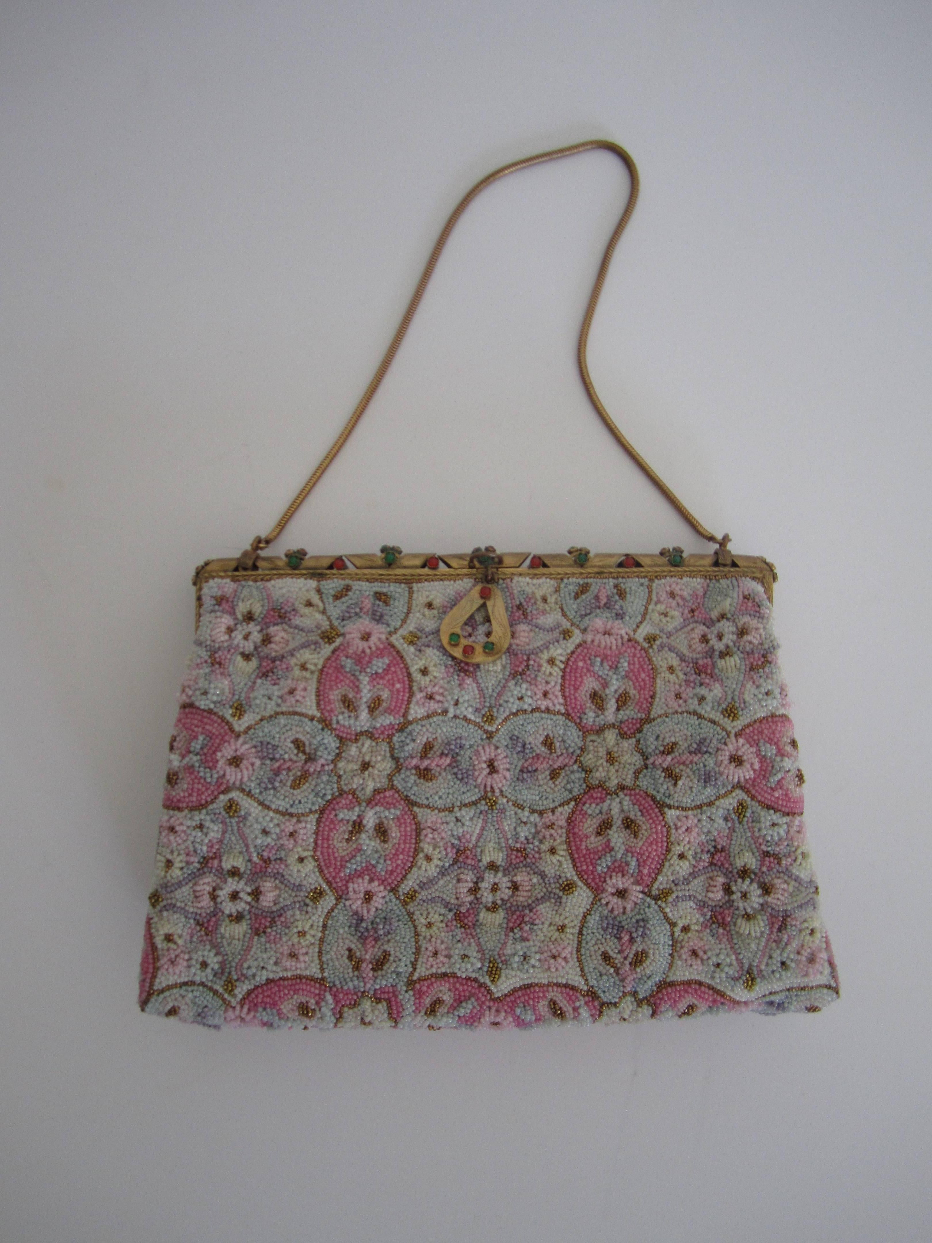 Exquisite French vintage beaded handbag with brass chain, detailed brass closure with set stones, satin interior with two side pouches, small satin snap purse, small beveled mirror, in original box with bow. Bead hues include pinks, whites, blues