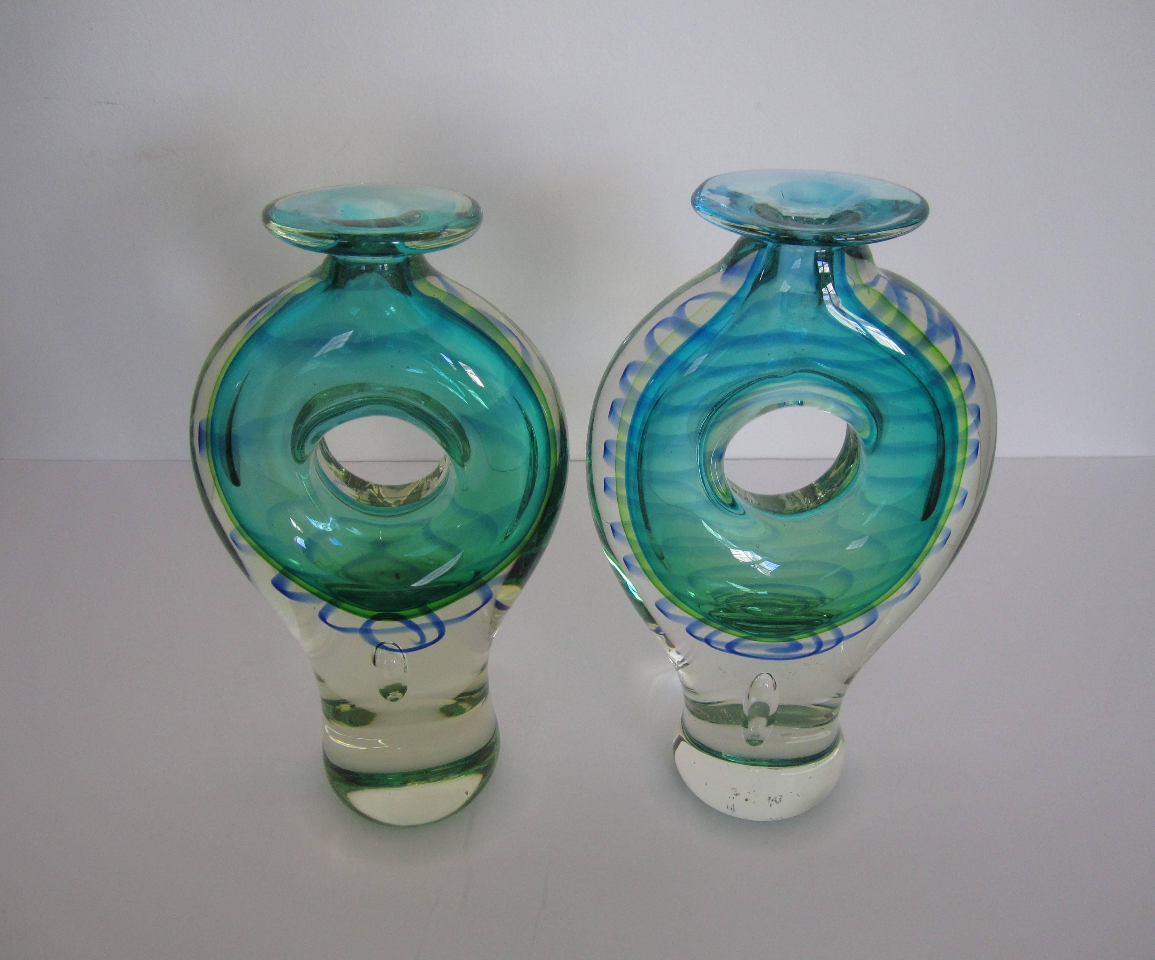 Pair/Set Available Here for $650

A colorful and substantial pair of Post-Modern clear art glass vessels or vases with green and blue glass hues. 

Measuring is approximately 10 in. H. 

Pair is available here online. By request, pair can be made