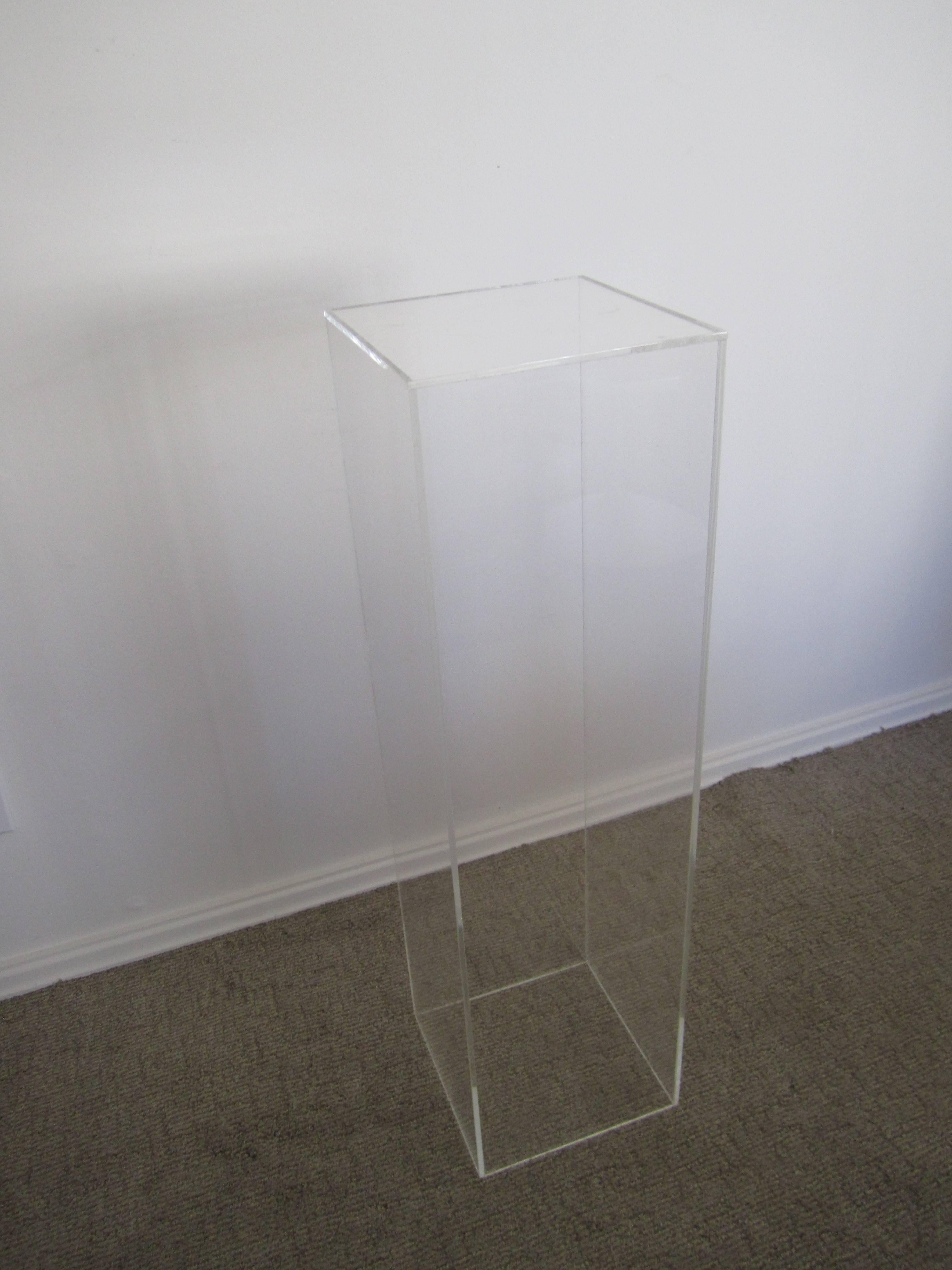 A 3' tall rectangular acrylic pedestal stand display piece for items such as art, sculpture, jewelry and more. Measurements include: 10