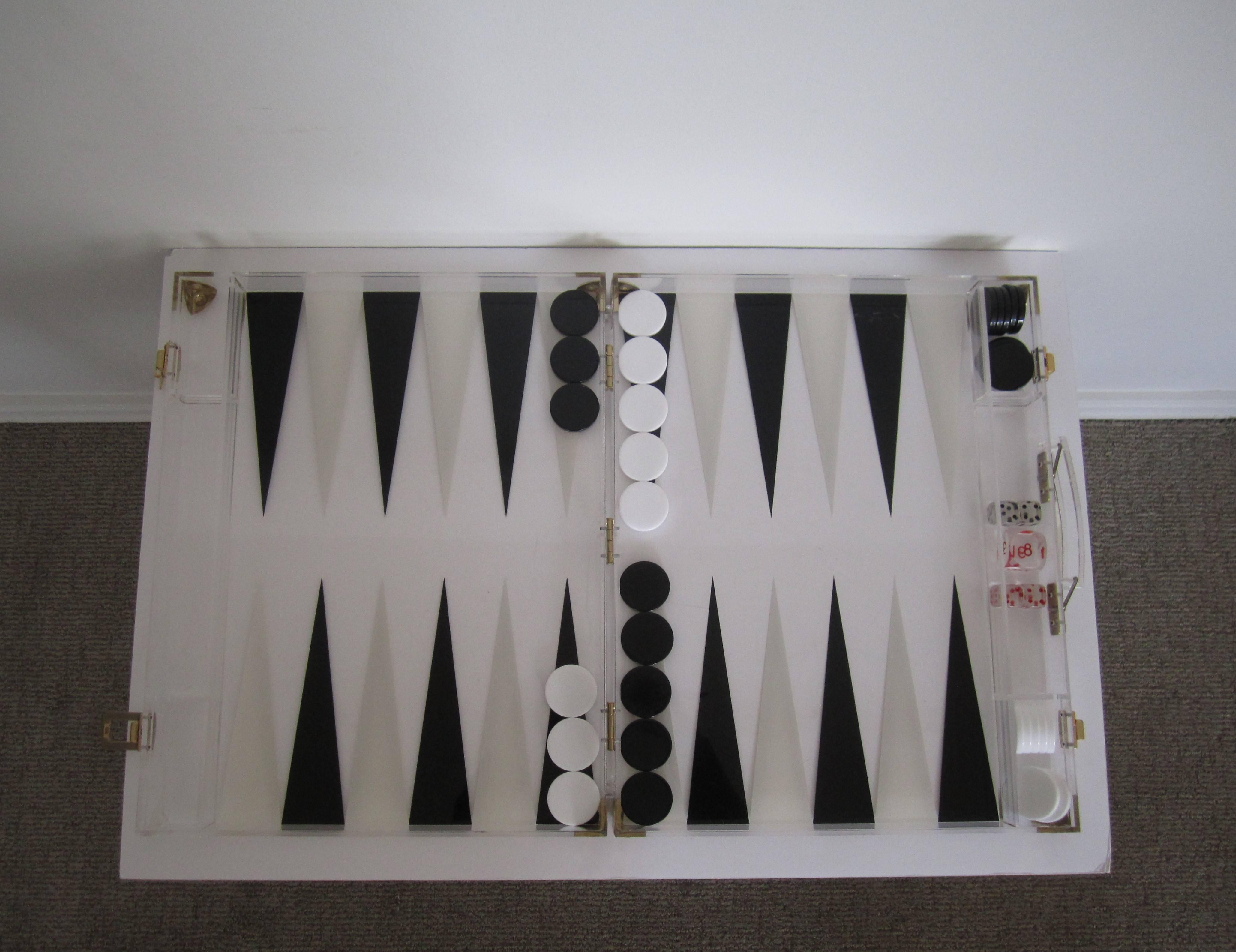 A vintage black and white backgammon game set in a portable acrylic case. Acrylic case is the game board. All pieces accounted for. Made in France, with maker's mark as seen in image. Circa 1970s. Measurements: Closed: 2.75