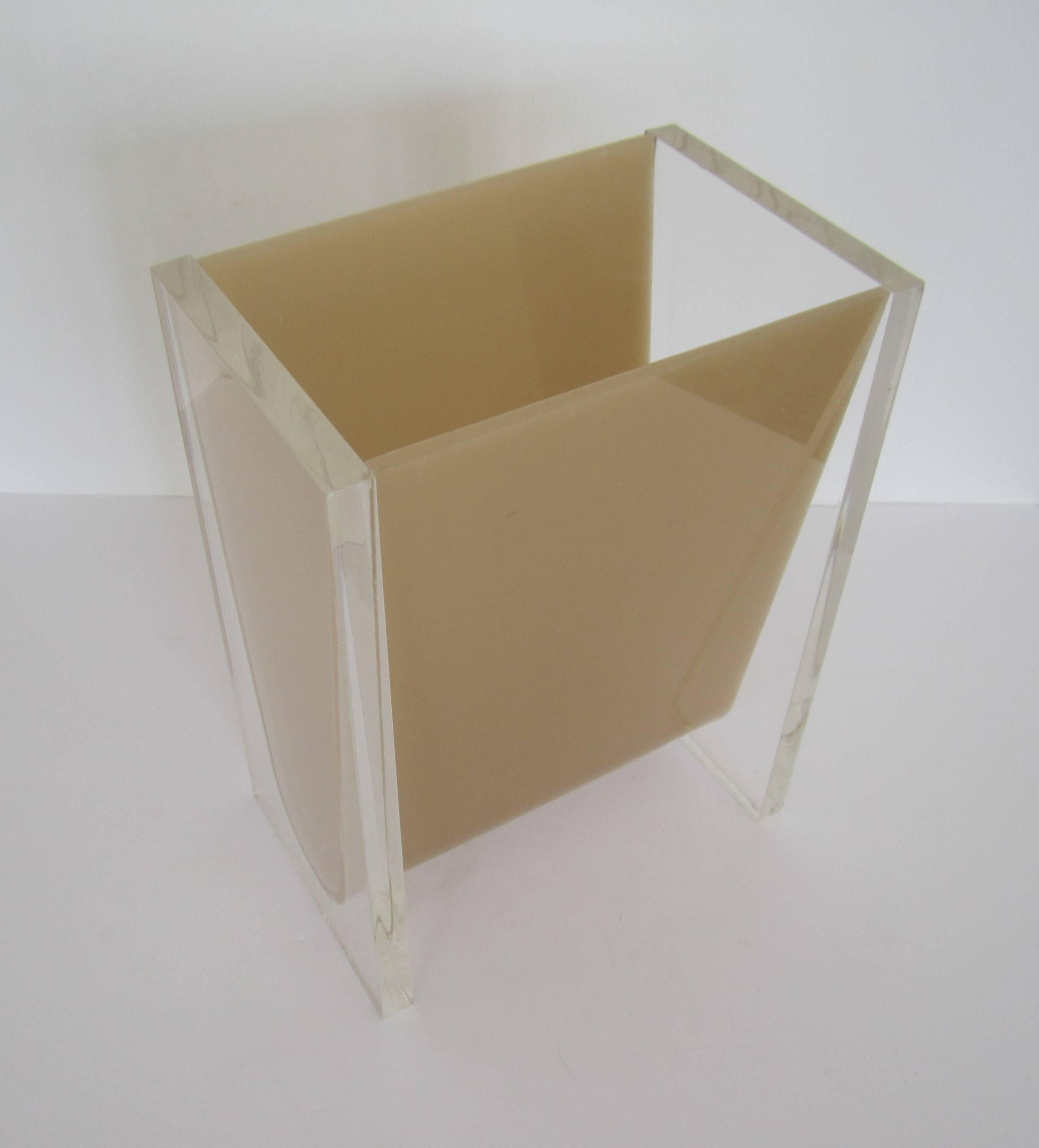 A vintage Lucite waste basket or trash can in the style of American Designer Charles Hollis Jones. Classic modern colors include clear Lucite rectangular ends with beige or tan acrylic center. Measurements include: 12