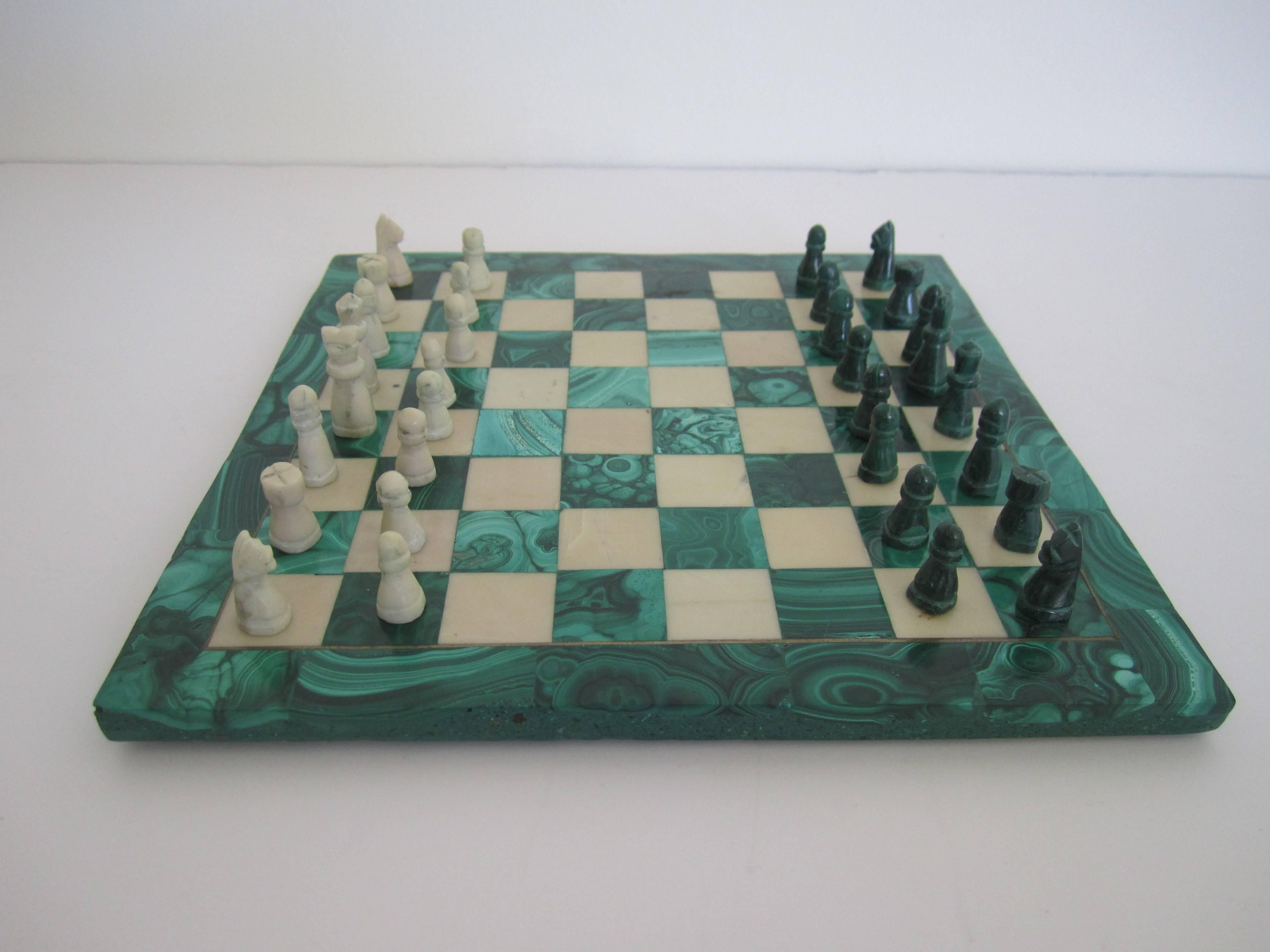 A vintage green malachite and marble chess set. Game board is made of green malachite and marble. Green and white game pieces are all hand-carved. All pieces accounted for; 32 + board. Board measures approximately 9