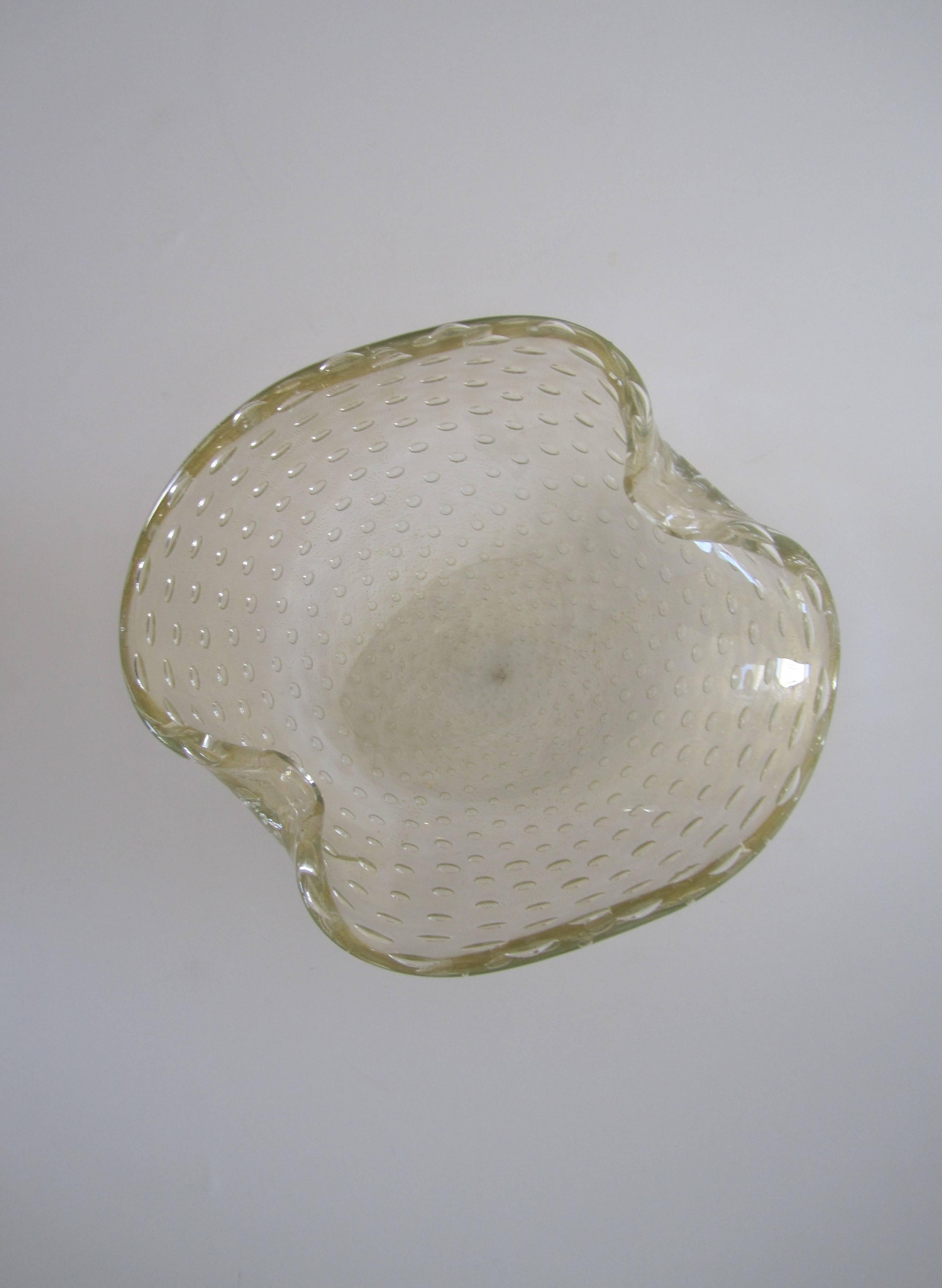 A beautiful vintage Italian Murano bowl. Bowl is clear glass mixed with shimmering gold with a 'controlled bubble' design, two intentional 'bent' interruptions, and a soft and beautiful finish in an organic form. Attributed to Italian designer