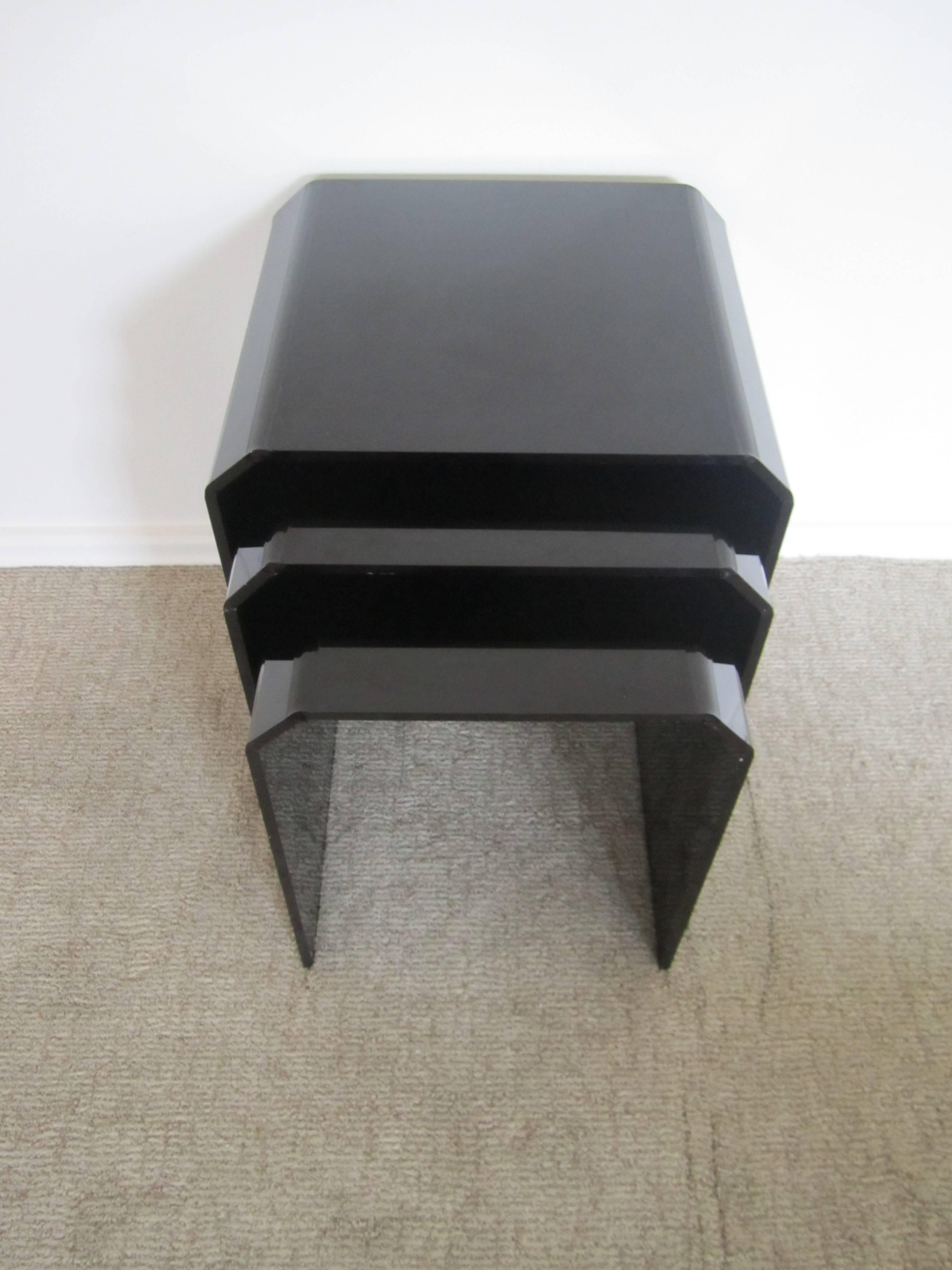 A trio (three) of Modern black acrylic nesting, end, or side tables with tapered corners. 

Measurements include: 
16.75 H x 13.5 W x 14 D
18.75 H x 15 W x 14& D
20 H x 15.25 W x 14 D

Set of three available here online. By request, set can be made