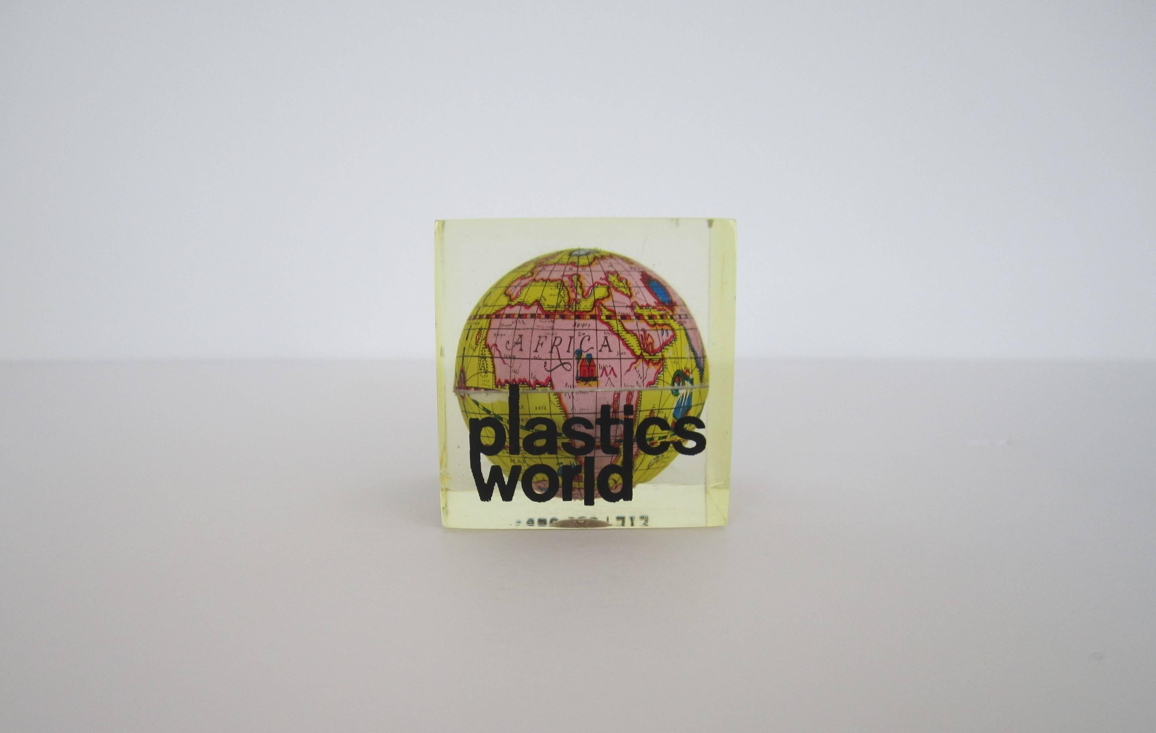 A vintage world globe encased in Lucite, ca. 1970s Modern. 
About address on cube: 205 East 42nd Street, New York, New York, is an Art Deco building in Midtown built in 1927.

Measures 1.75