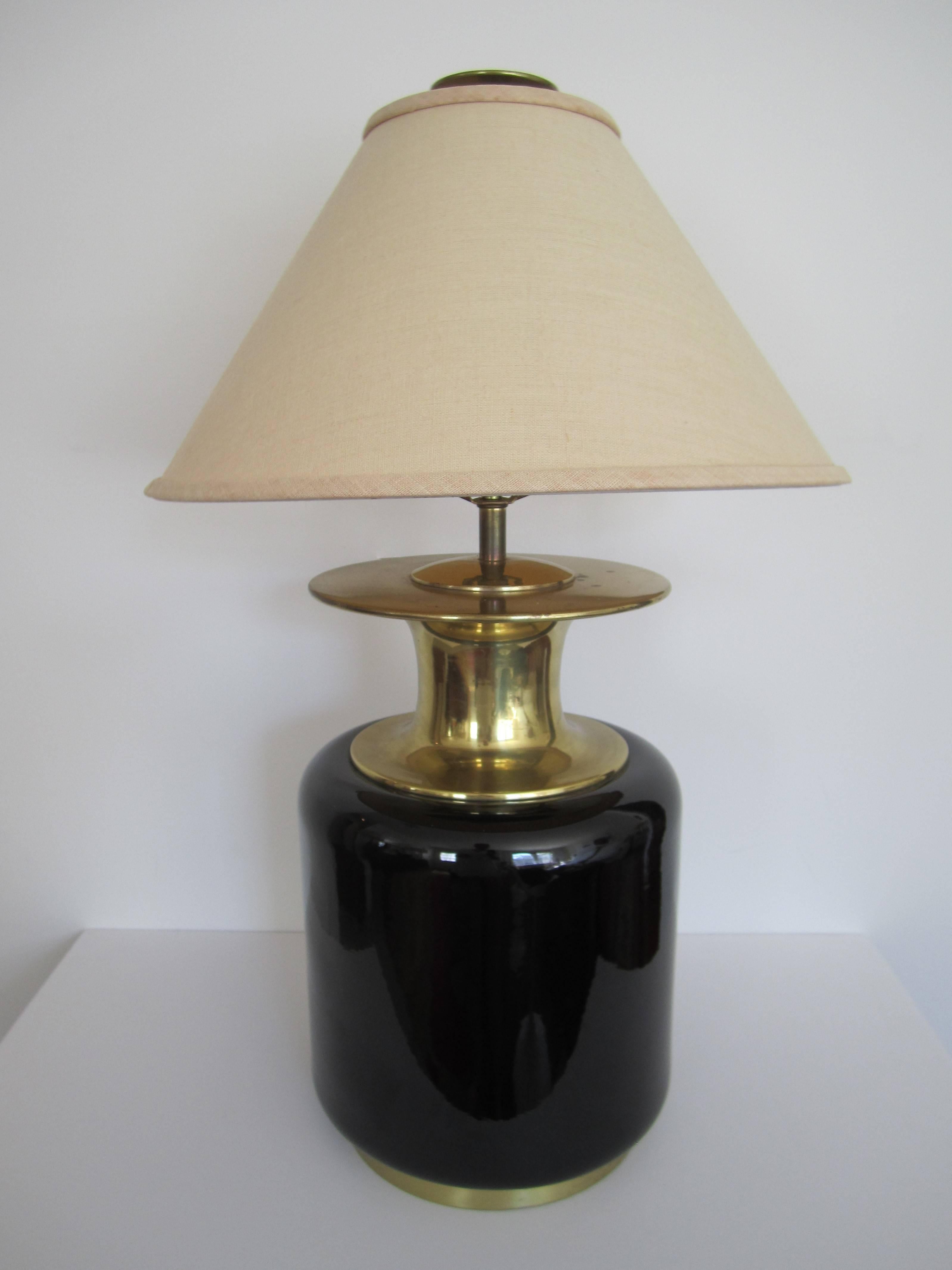 A relatively large, black glazed ceramic and brass table lamp by Chapman, Post-Modern period, circa 1980s. Table lamp Includes original large round brass finial. Maker's mark at socket: 