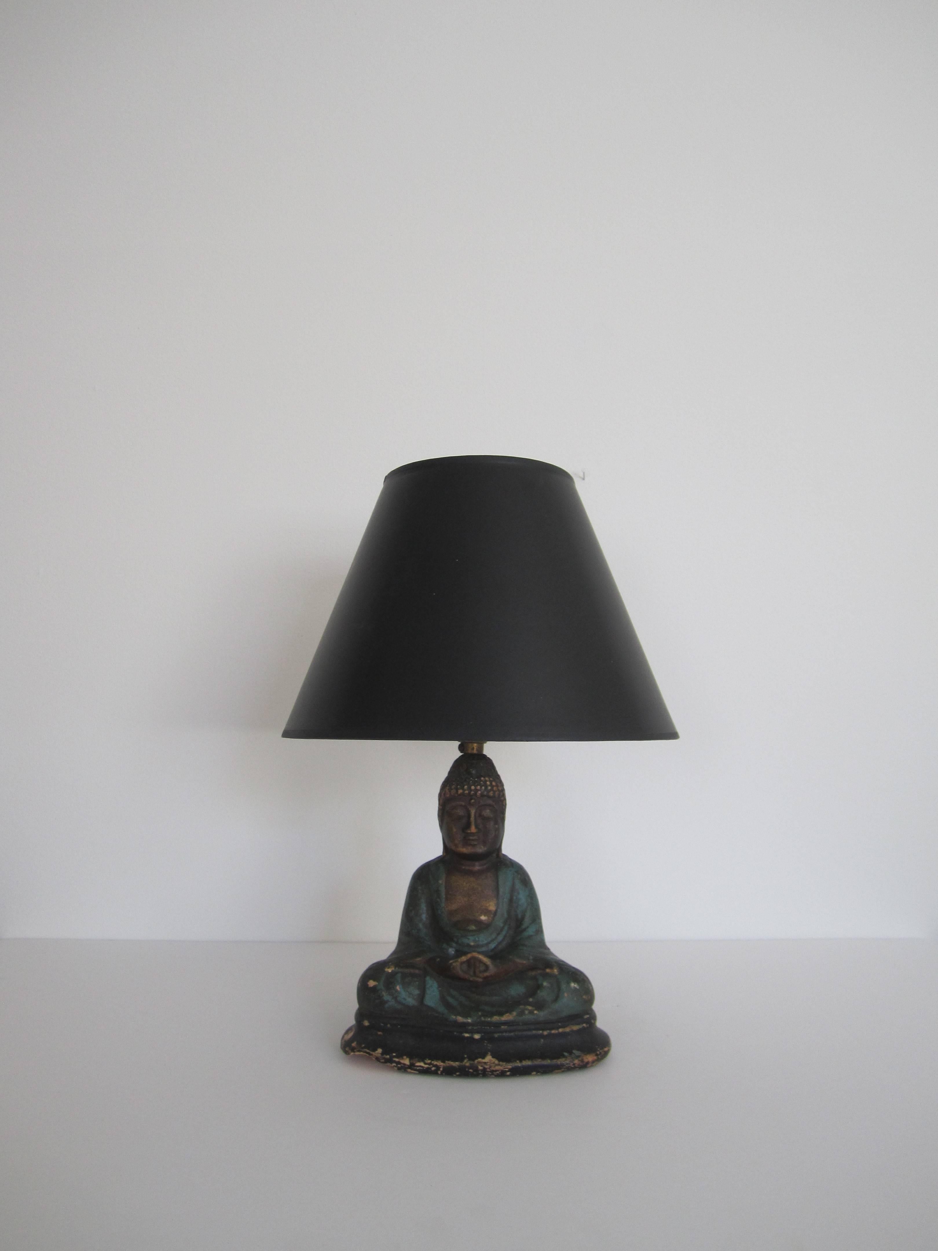 A beautiful antique hand-painted seated Buddha desk or table lamp, circa 1920s. There are several special characteristics of a Buddha; specific to this Buddha they include a forehead dot aka the cosmic eye, long earlobes and three folds on neck.