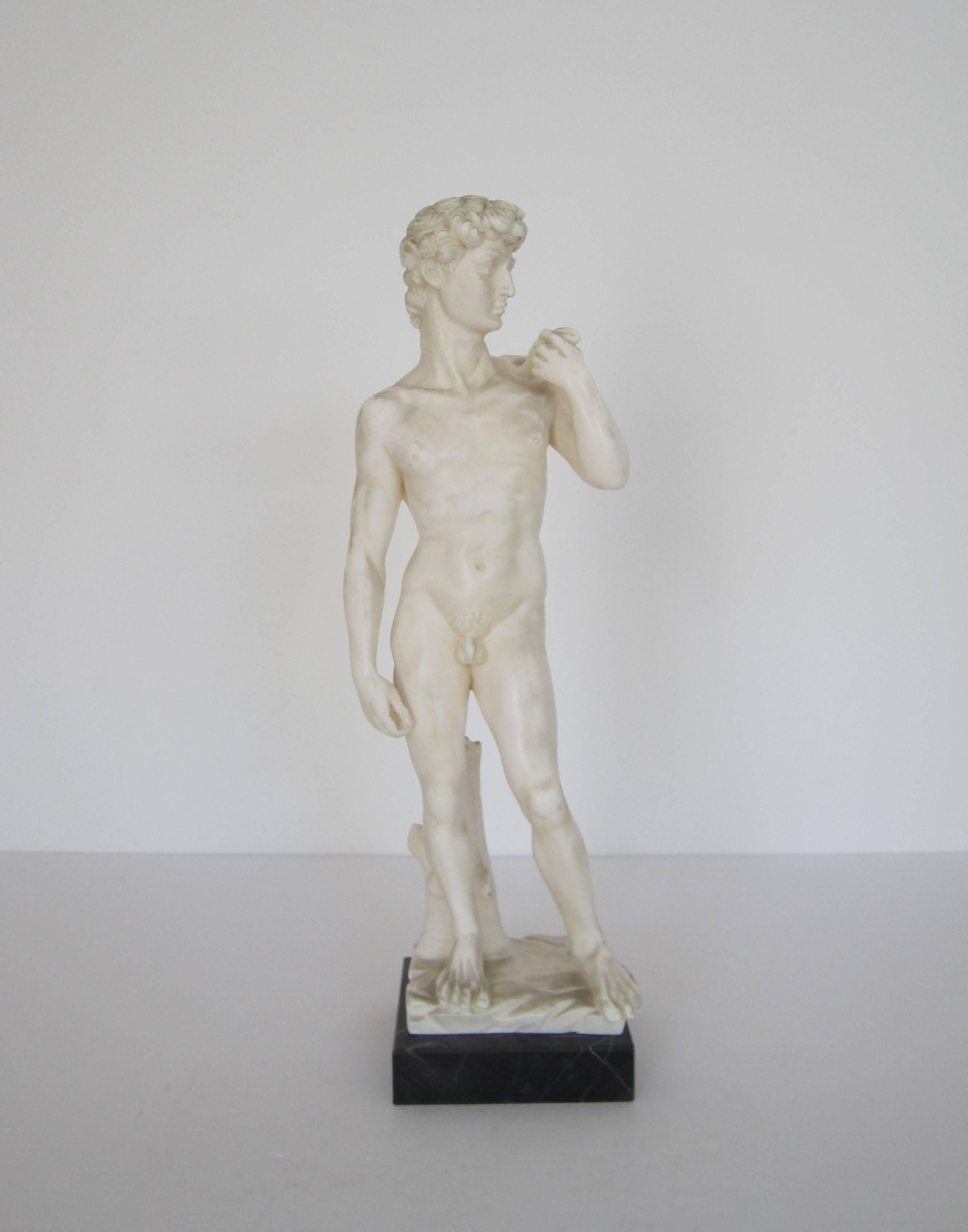 A Mid-20th century classic Italian Roman statue of the 'David' on a black marble base by sculptor G. Ruggeri, Italy. White resin statue is on a black marble base with tan veins. With maker's mark's and marked 'Made in Italy' as show in images #9 and