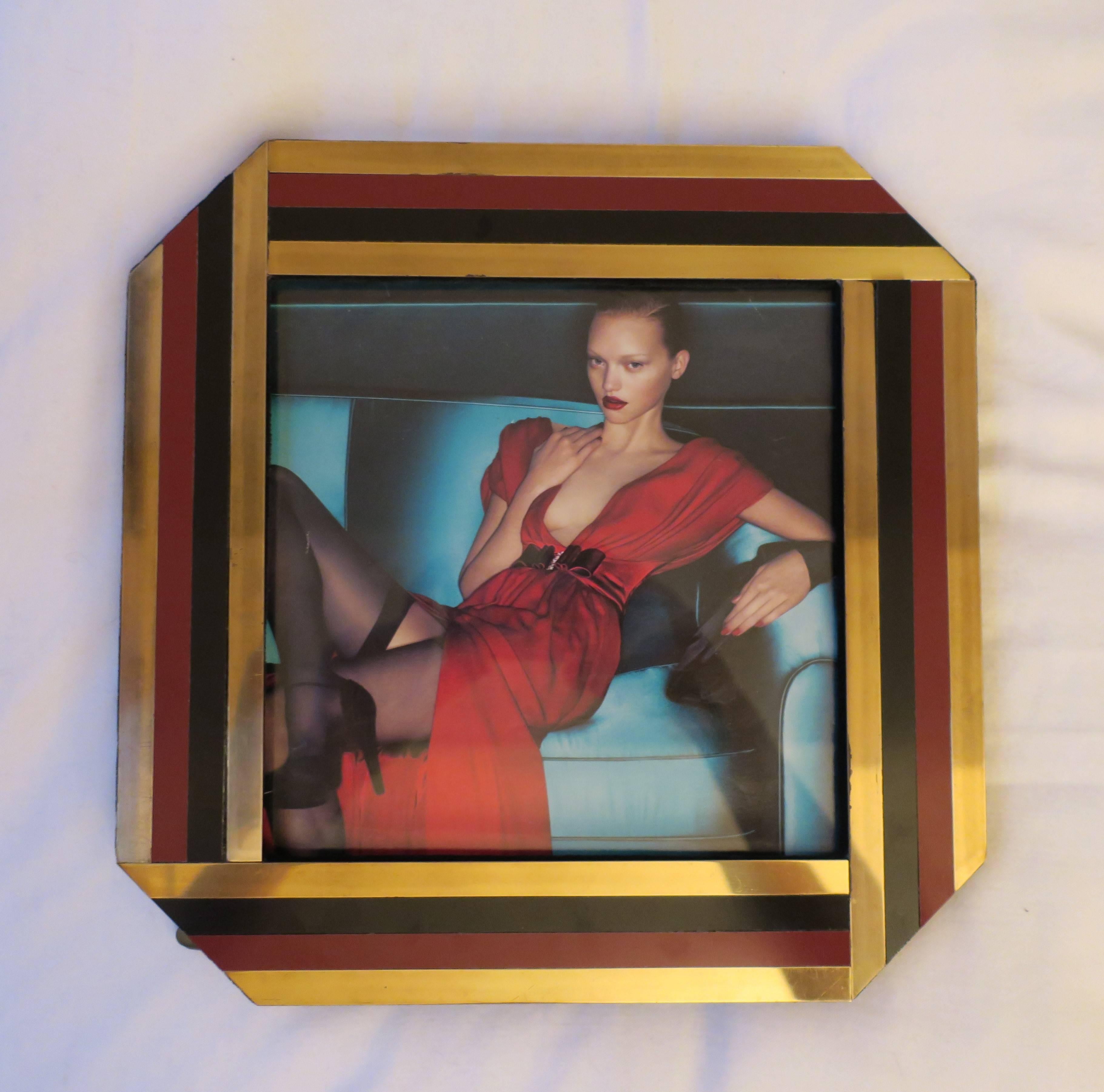 A chic '70s Modern Italian square picture frame with tapered corners, circa 1970s Italy. Colors include gold brass, black and red burgundy. With maker's mark label on back (underneath easel stand, not visible from image #10): Noel B.C., Italy. Easel