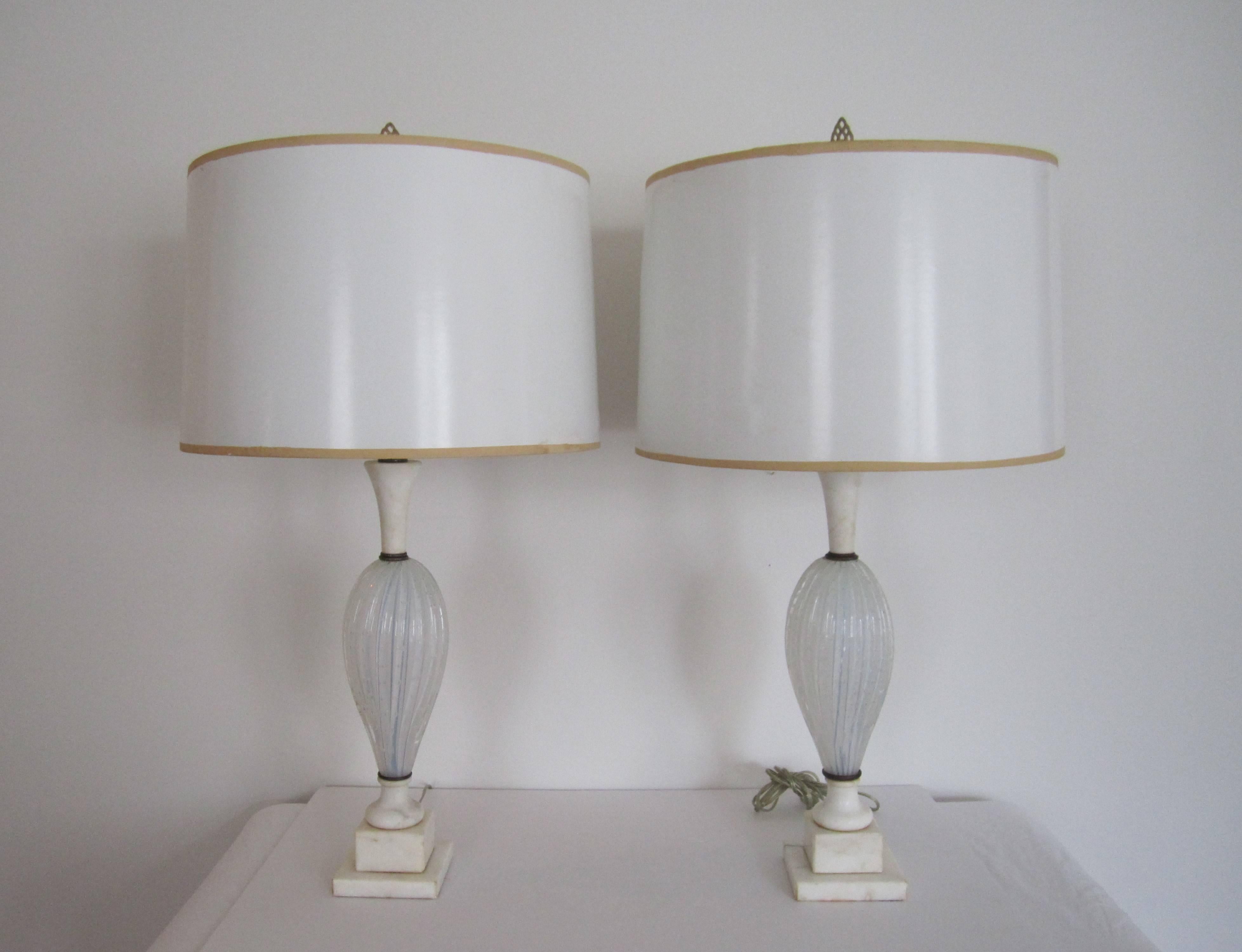 A beautiful pair of Italian Seguso white opaline Murano art glass and white Italian marble neck and pedestal base table lamps. Pair are made of handblown white opaline, with a slight iridescence, Murano art glass with controlled bubble and twist