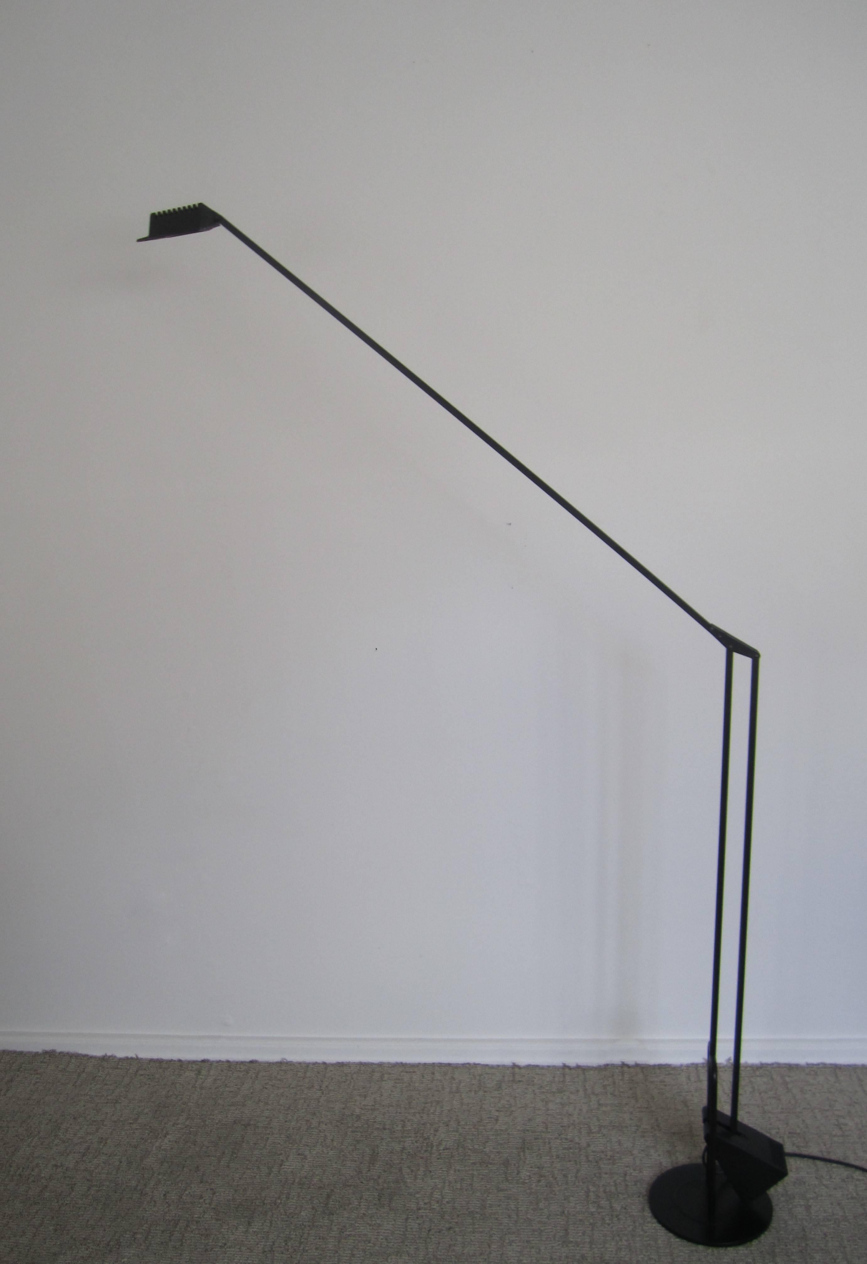 An amazing Minimalist Post-Modern [Postmodern] Italian black adjustable floor lamp by designer Fridolin Naef for LUXO, Italy, ca. 1980s. This floor lamp is known as the MOD Flamingo; a black metal sleek adjustable floor lamp - adjusting up to 73