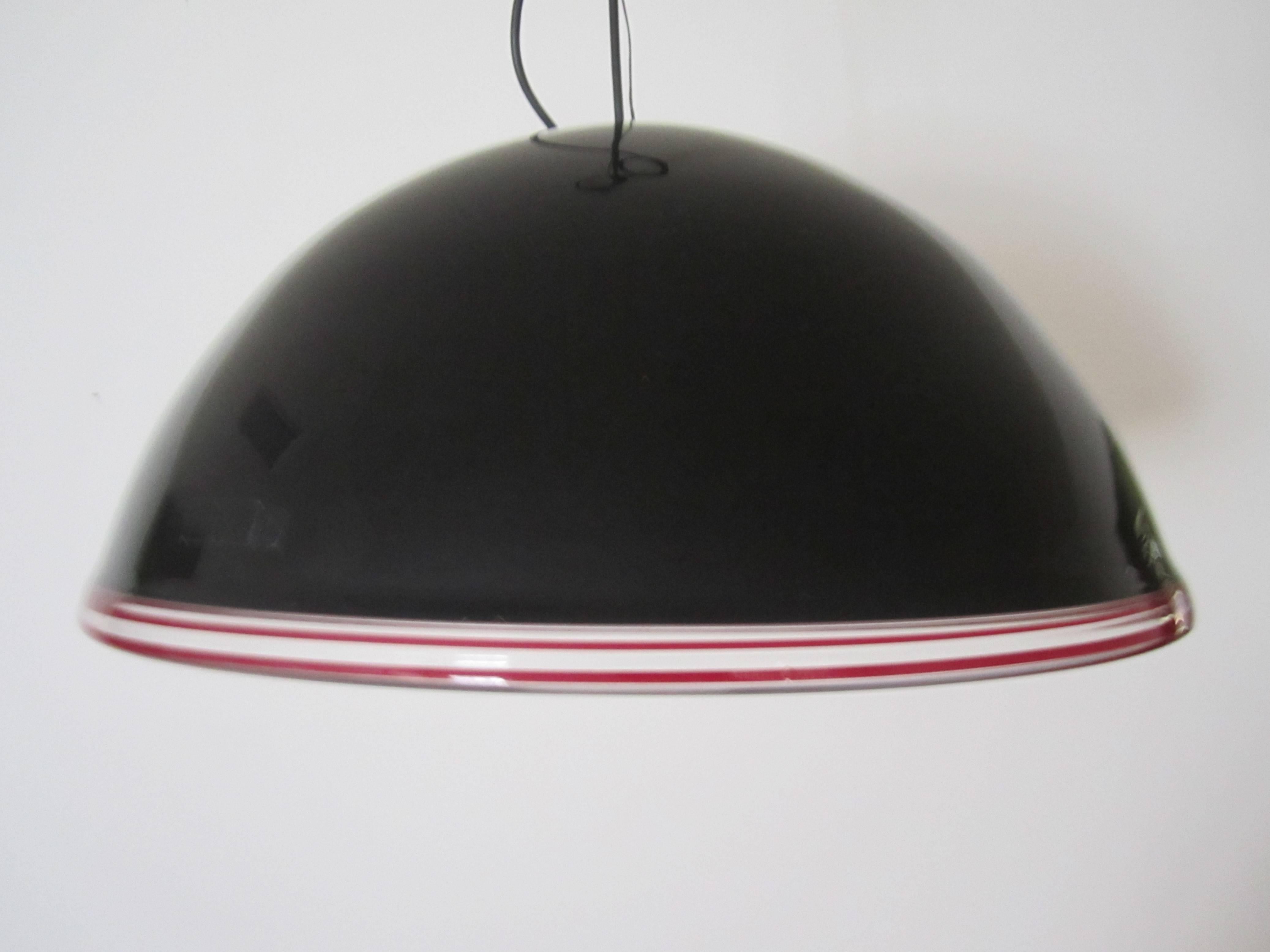 A beautiful and relatively large modern style or Post-Modern period Italian Murano black art glass dome chandelier pendant light. Murano glass is predominantly black with clear and red/burgundy art glass trim. With marker's mark, 'Effetre