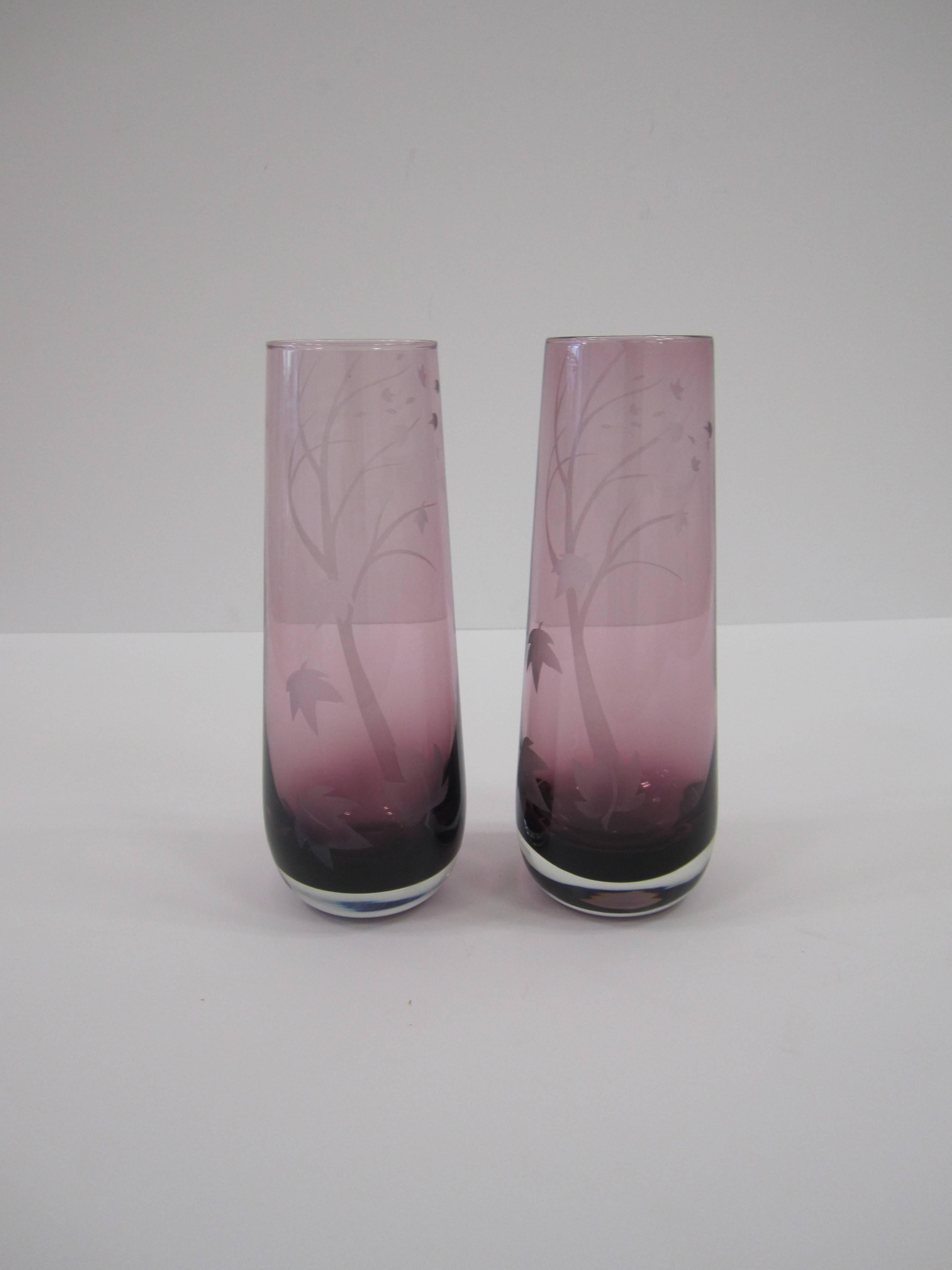 A pair of beautiful and substantial amethyst purple signed art glass vases, 1982. Art glass vases have an etched large tree design with free flowing leaves, initialed and signed 'Autumn Leaves 1982' on bottom as show in image #3. 

Measures: 9
