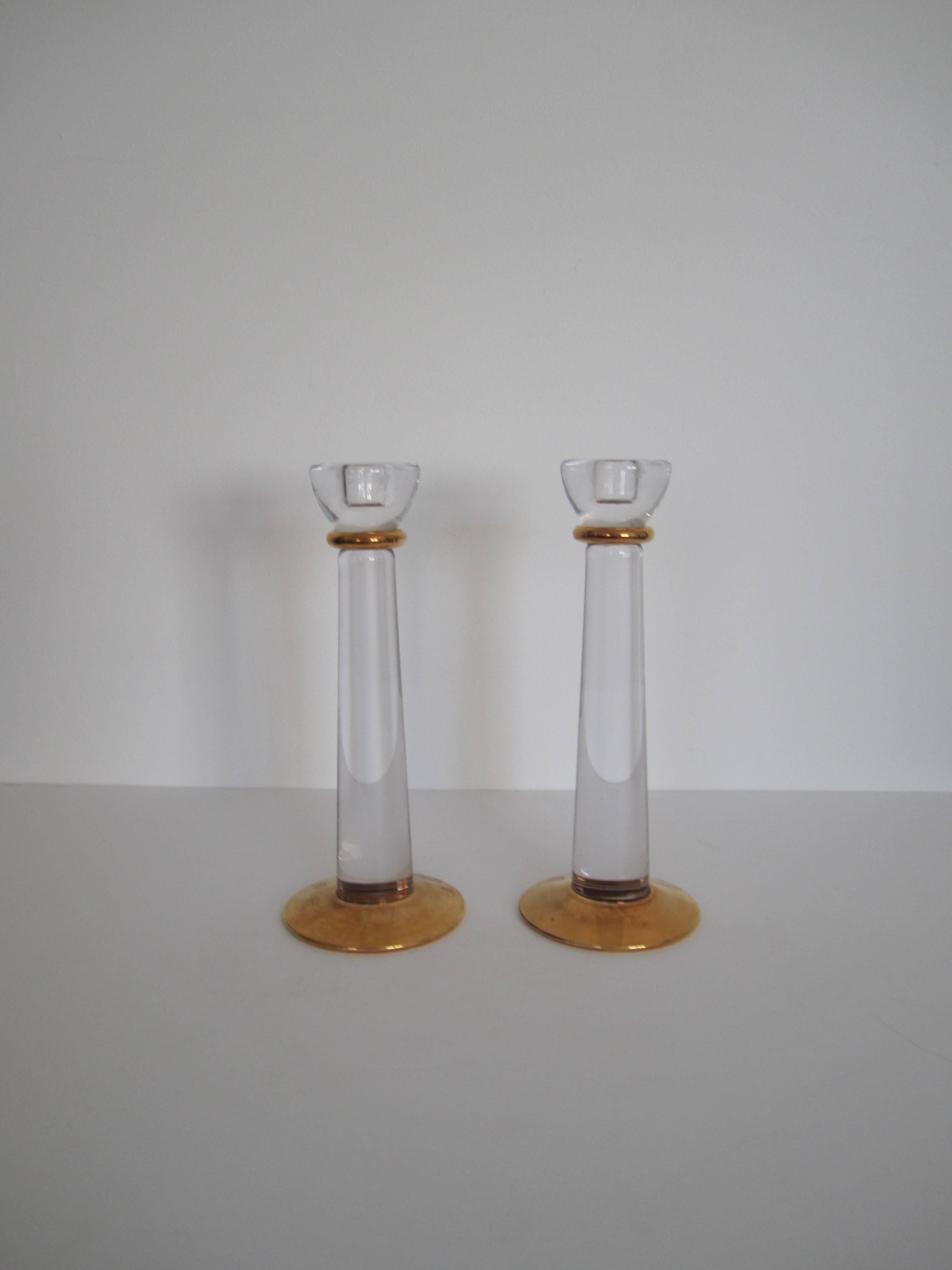 A beautiful and substantial pair of Scandinavian clear crystal and gold hand-painted candlestick holders by Kosta Boda from Sweden, circa 1990s. With maker's mark as show in image #10. 

Measurements: 10 in. H x 4 in. Diameter base

Pair available