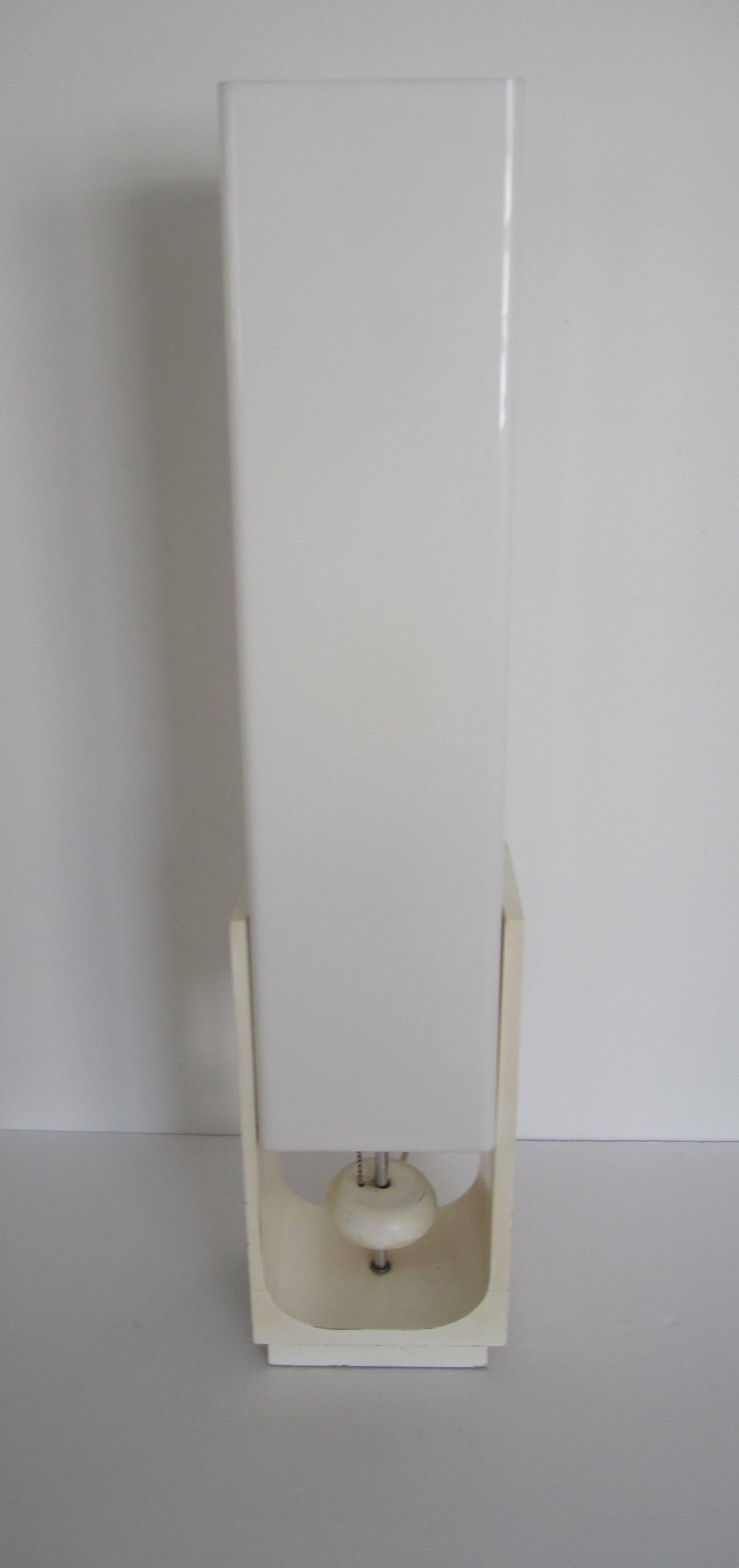 A tall Modern white acrylic or Lucite style and white lacquered wood table or low floor lamp, with a white wood 'ball' on/off switch a center base area, circa mid-20th century, 1960s. Fixture can handle a three-way bulb. In working order.