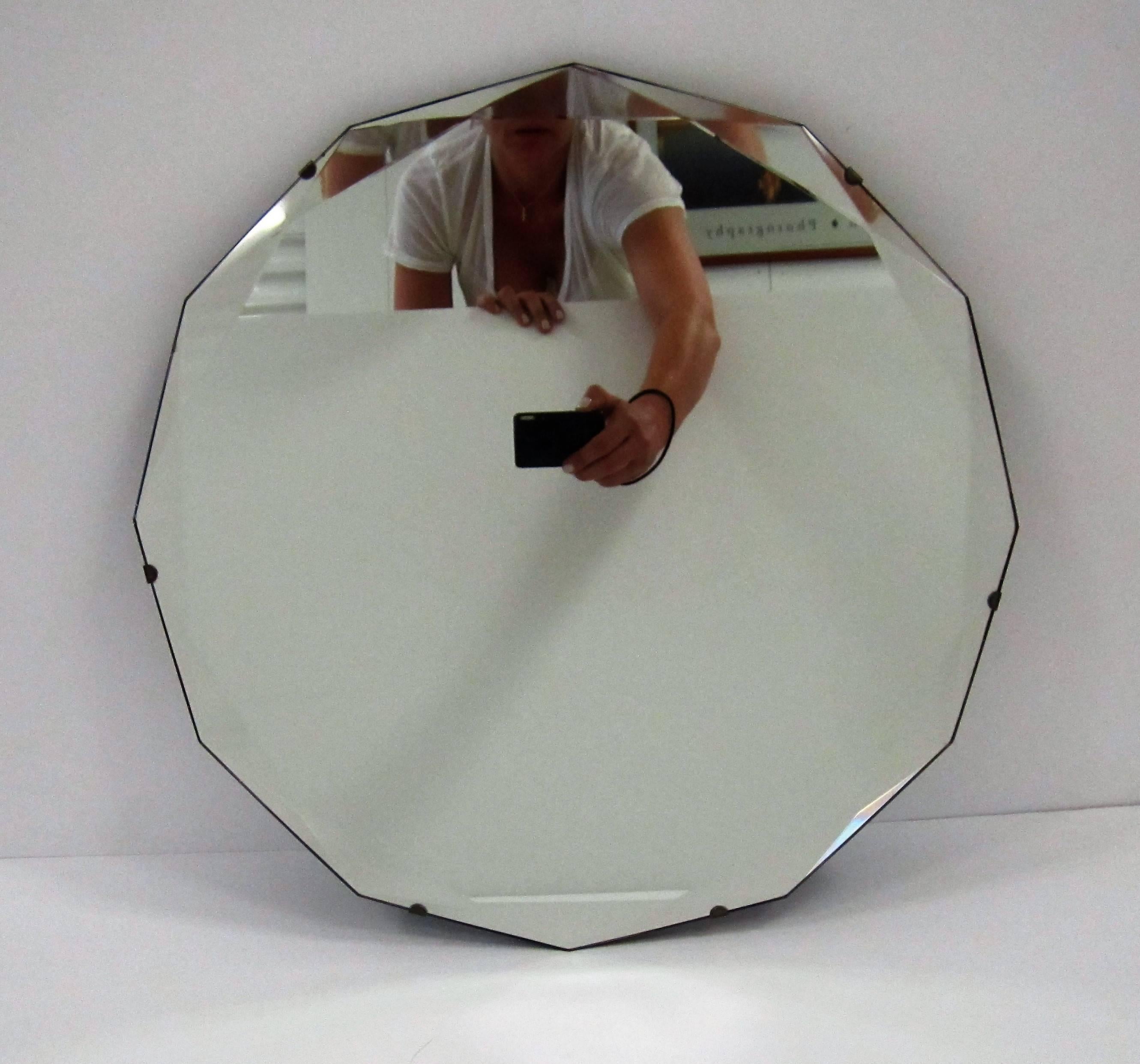 A beautiful vintage Hollywood Regency style 12 sided (dodecagon) beveled edge wall mirror. Beautiful intersecting bevel at each point (12) around mirror edge. Mirror would make a very nice vanity, dressing room, bath, etc., area mirror. 

Mirror is