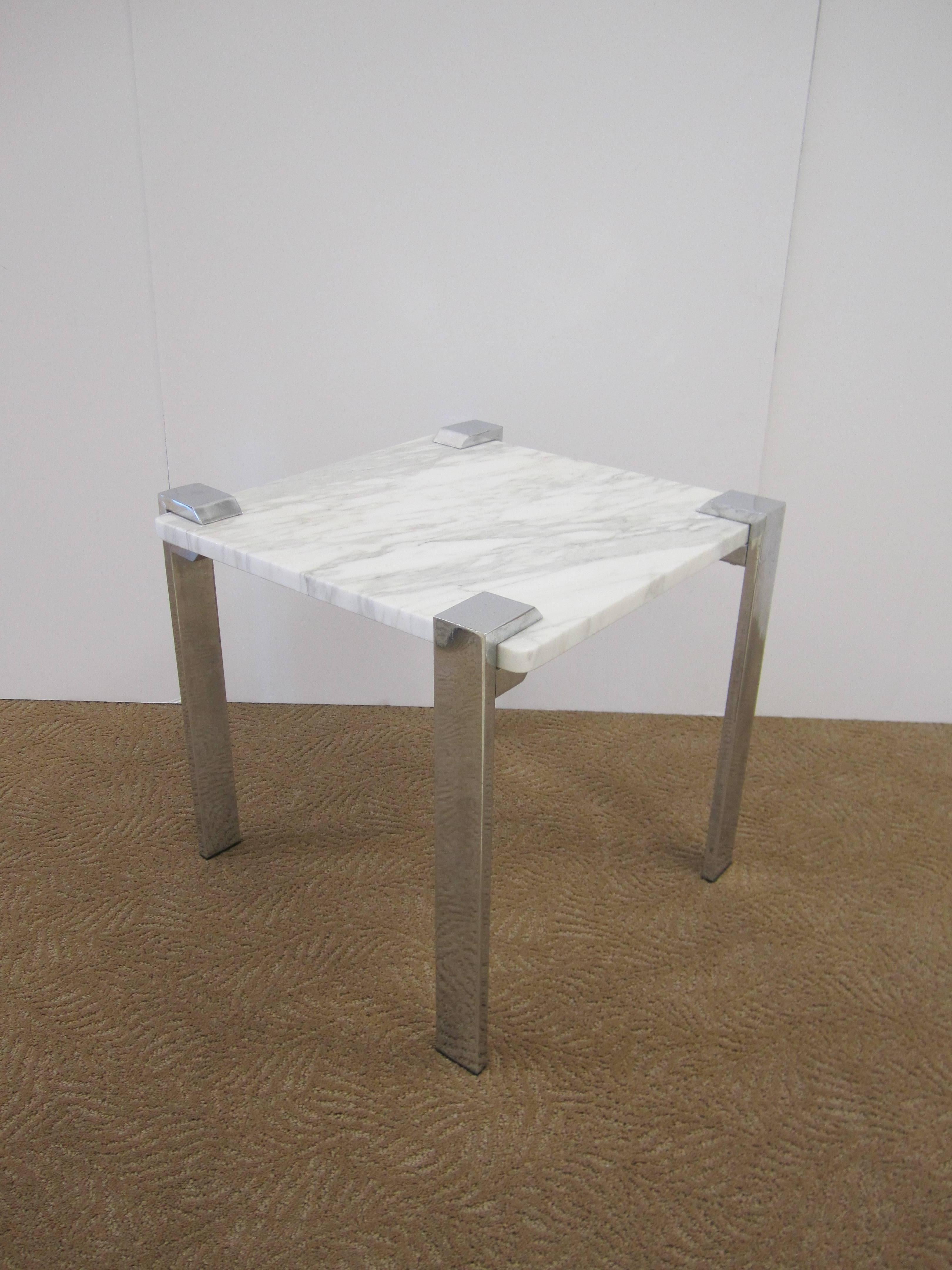 An Italian Modern chrome and marble side or end table from Italy, circa 1970s. Marble is white and grey, measuring 3/4 in. thick. Chrome base embraces marble top with rectangular legs. Marked Made in Italy in several places as show in images.