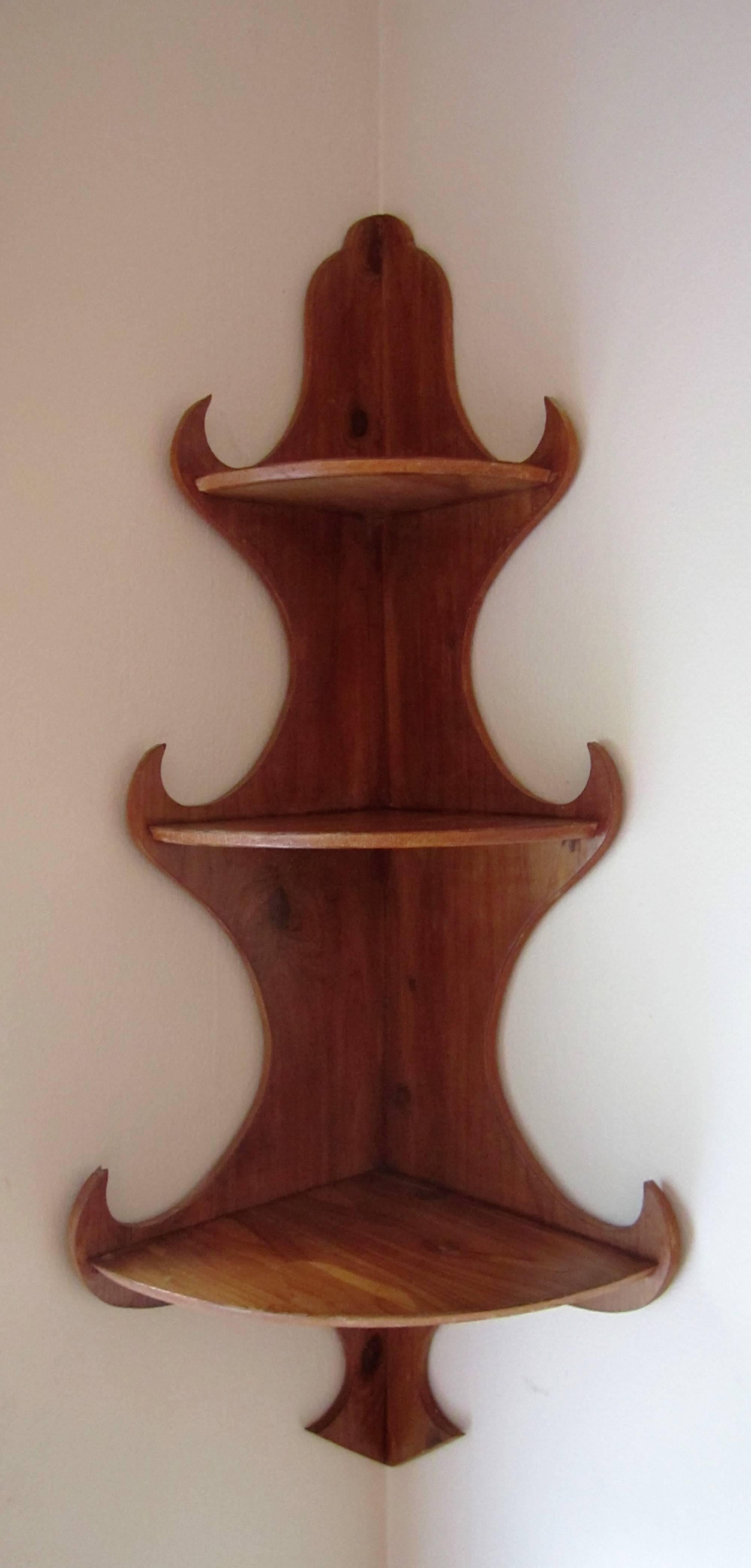 A beautifully constructed vintage hanging corner wall wood shelf. The construction is dovetailed and well made. The scale of the shelves are shown in images with decorative pieces. 

Measurements include: 23