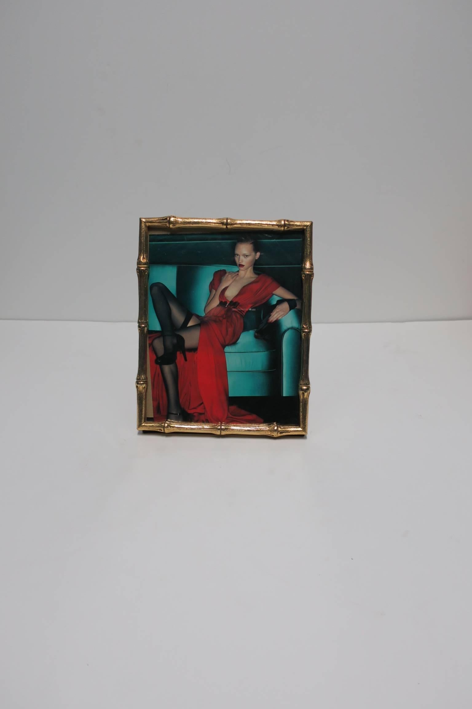 A beautiful and substantial gold 'bamboo' picture frame in the Hollywood Regency style, ca. late 20th Century. Picture frame can sit horizontally or vertically, or 'hang' vertically by two small metal loops on back of frame as show in images. Velvet