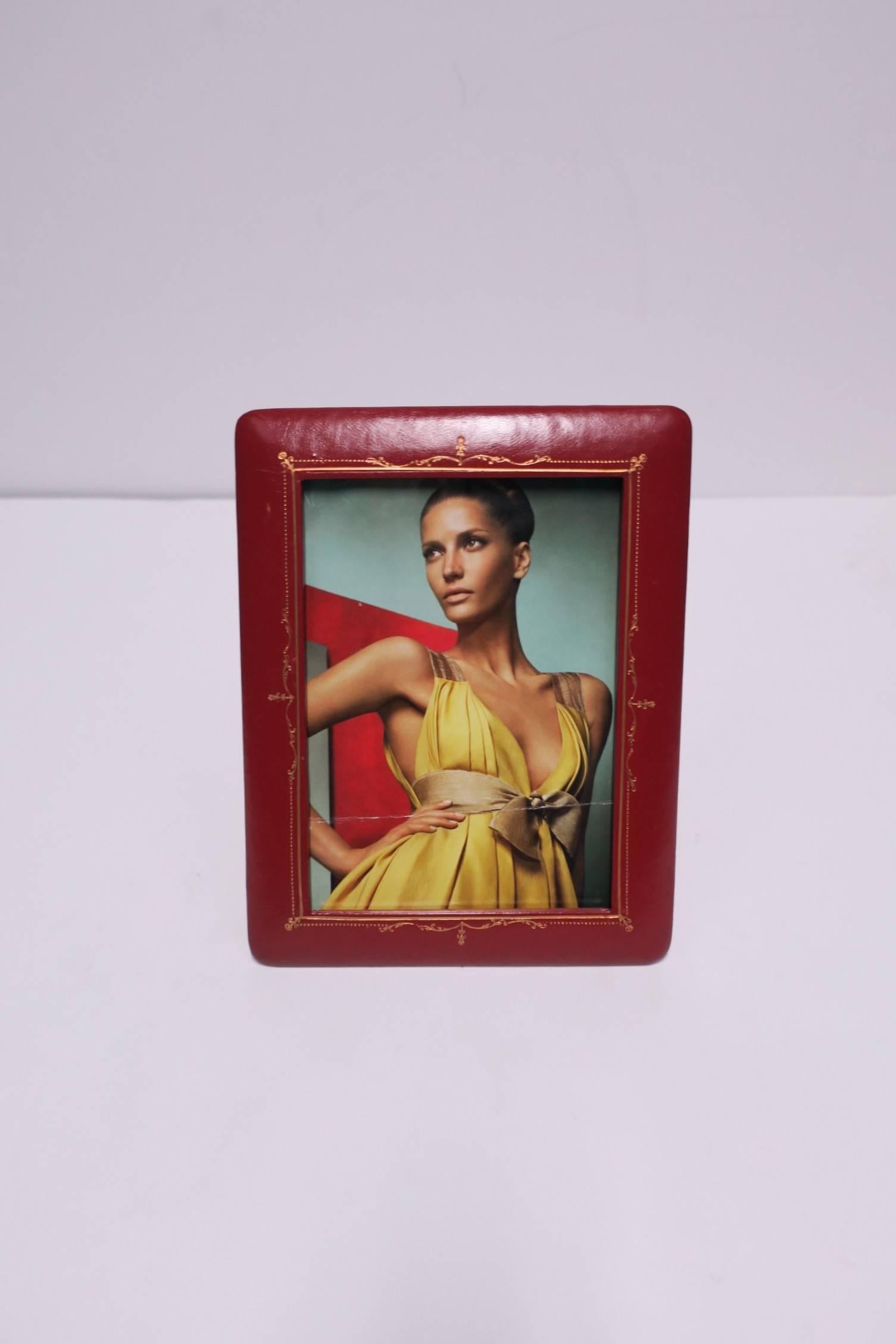 A beautiful vintage Italian red leather picture frame embossed with gold details from Florence, Italy. Maker's mark on back as shown in image. Frame measures 9