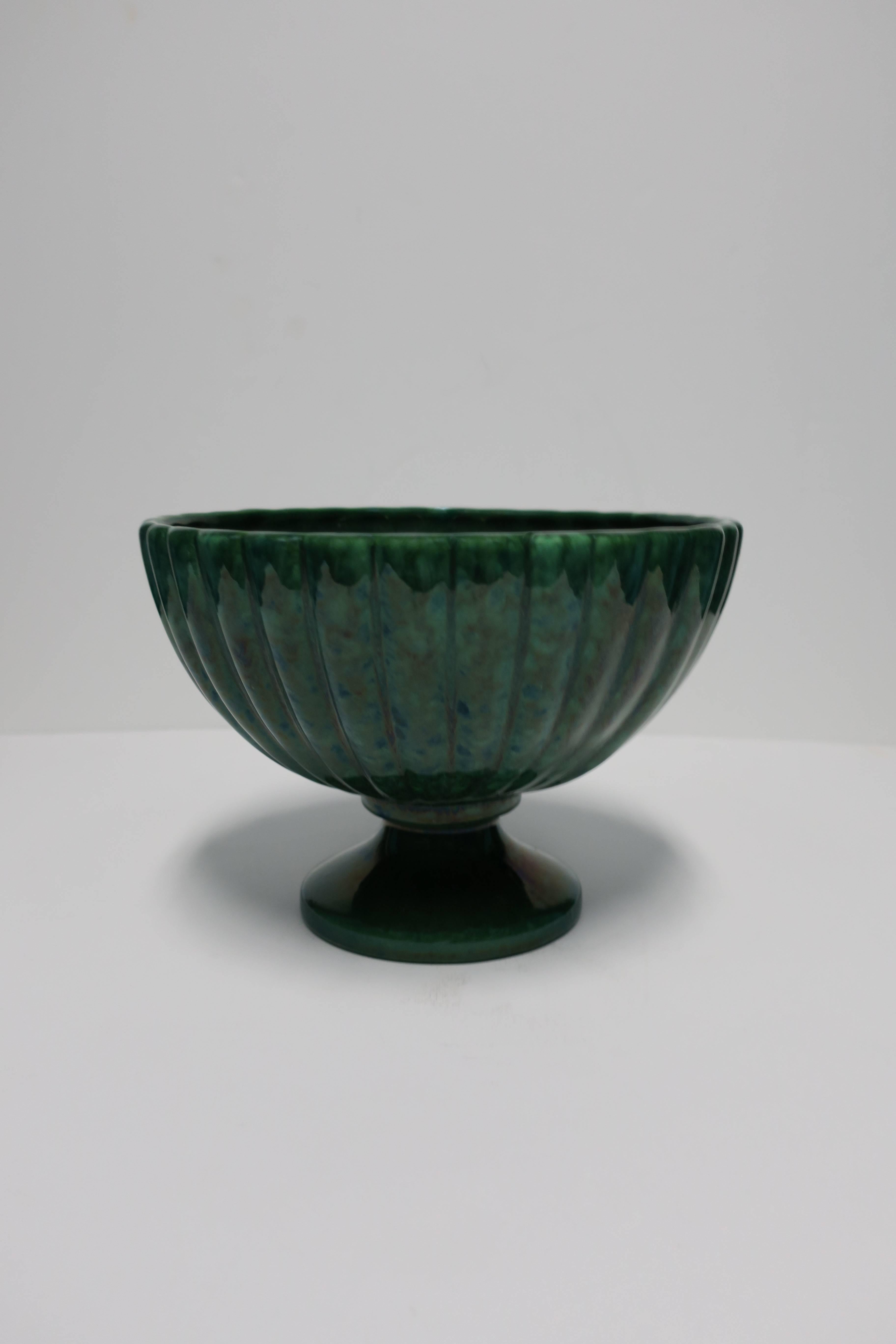 A beautiful vintage large Art Deco hunter green fluted glazed pottery urn with round pedestal base, circa 1930s. With maker's mark on bottom as shown in image. Measurements include: 7