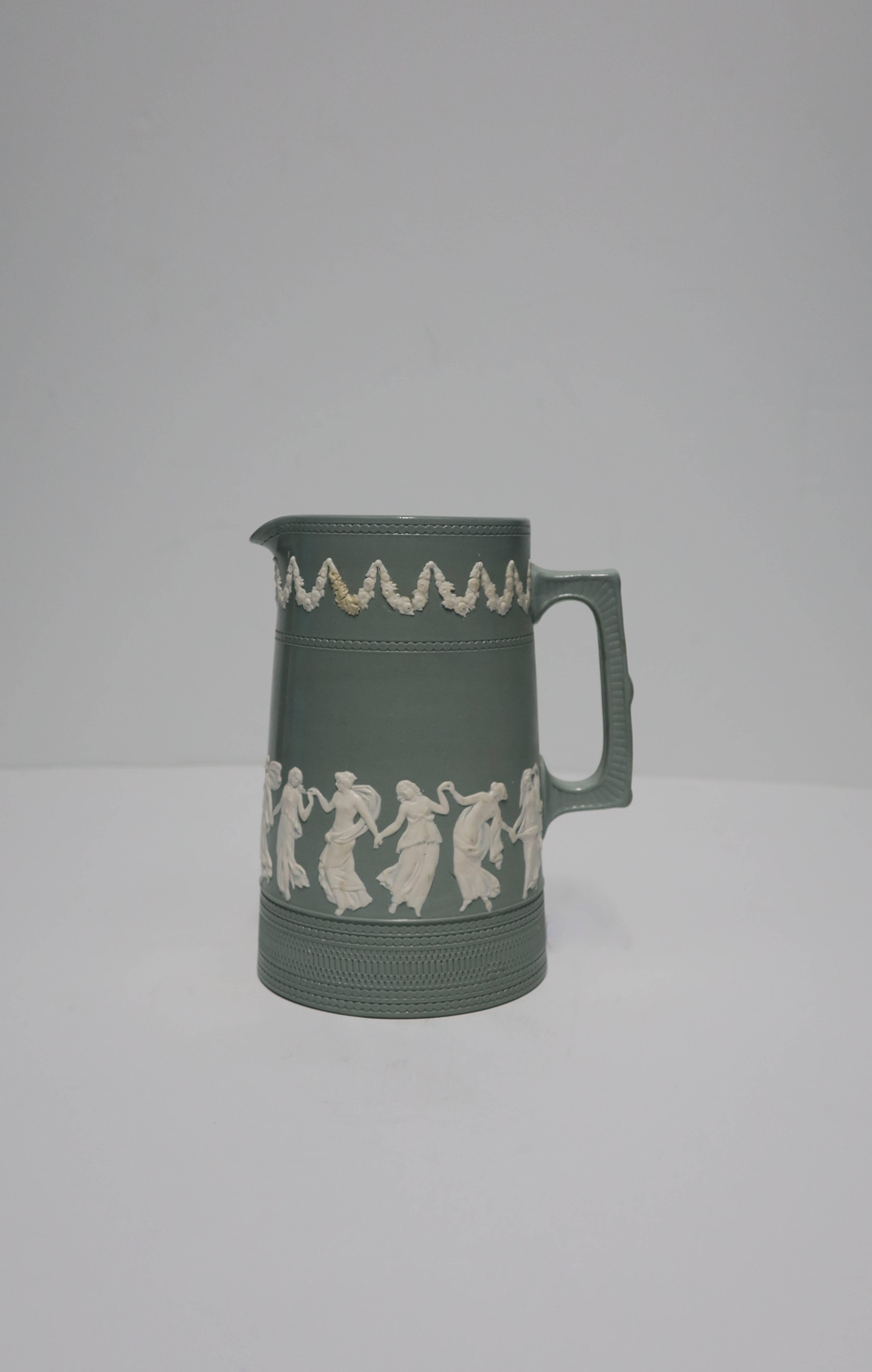 Al light green and white raised relief Jasperware pitcher by Copeland, in the Neoclassical style, circa 19th century, England. Beautiful as a standalone piece on a table, shelf, etc. Use as a pitcher, vase, etc. With maker's mark (Copeland, England)