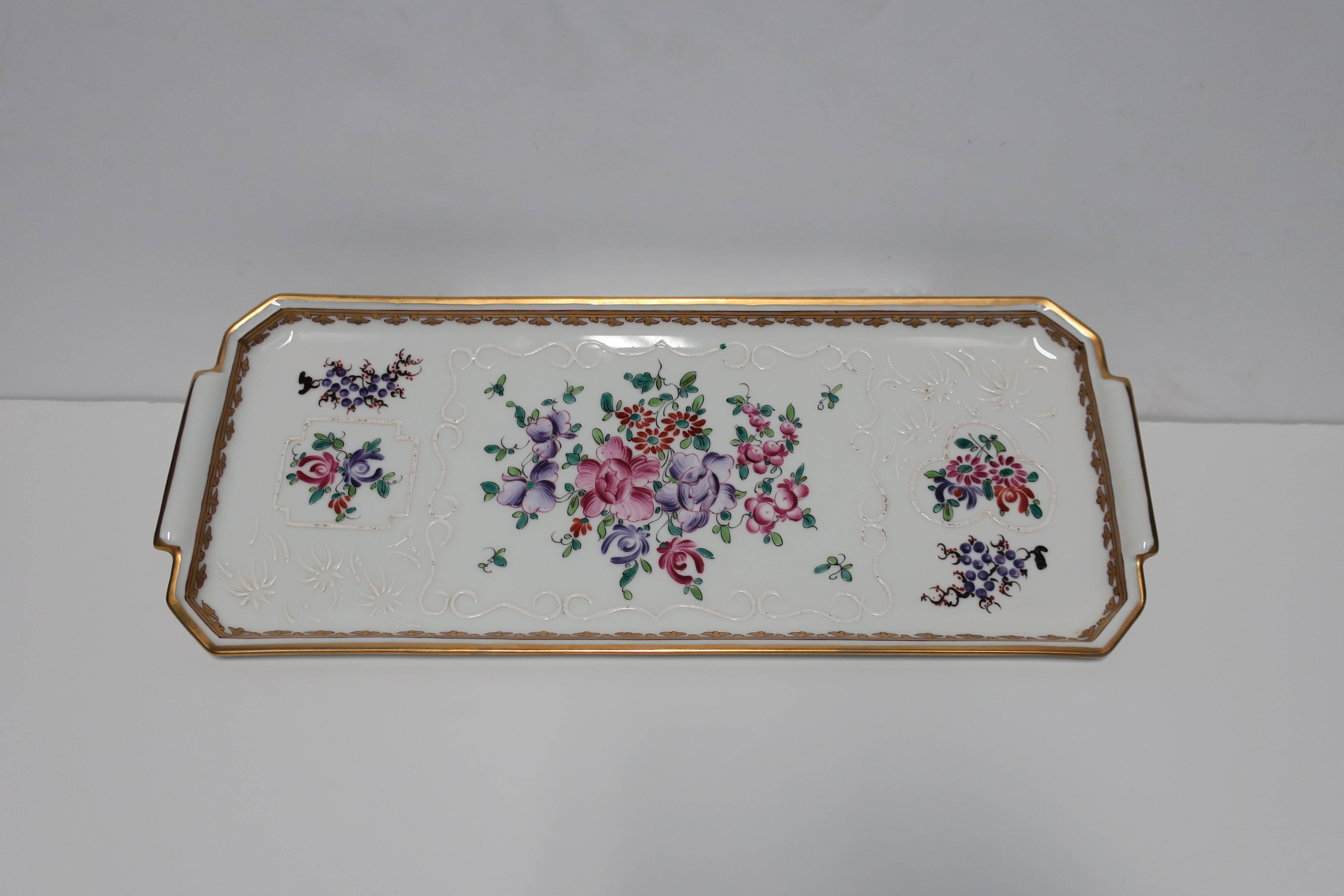 A beautiful vintage French hand-painted porcelain rectangular tray or serving piece with floral motif and gold trim. With marker's mark on bottom as shown in image #8; Paris, France.

Tray measures: 5