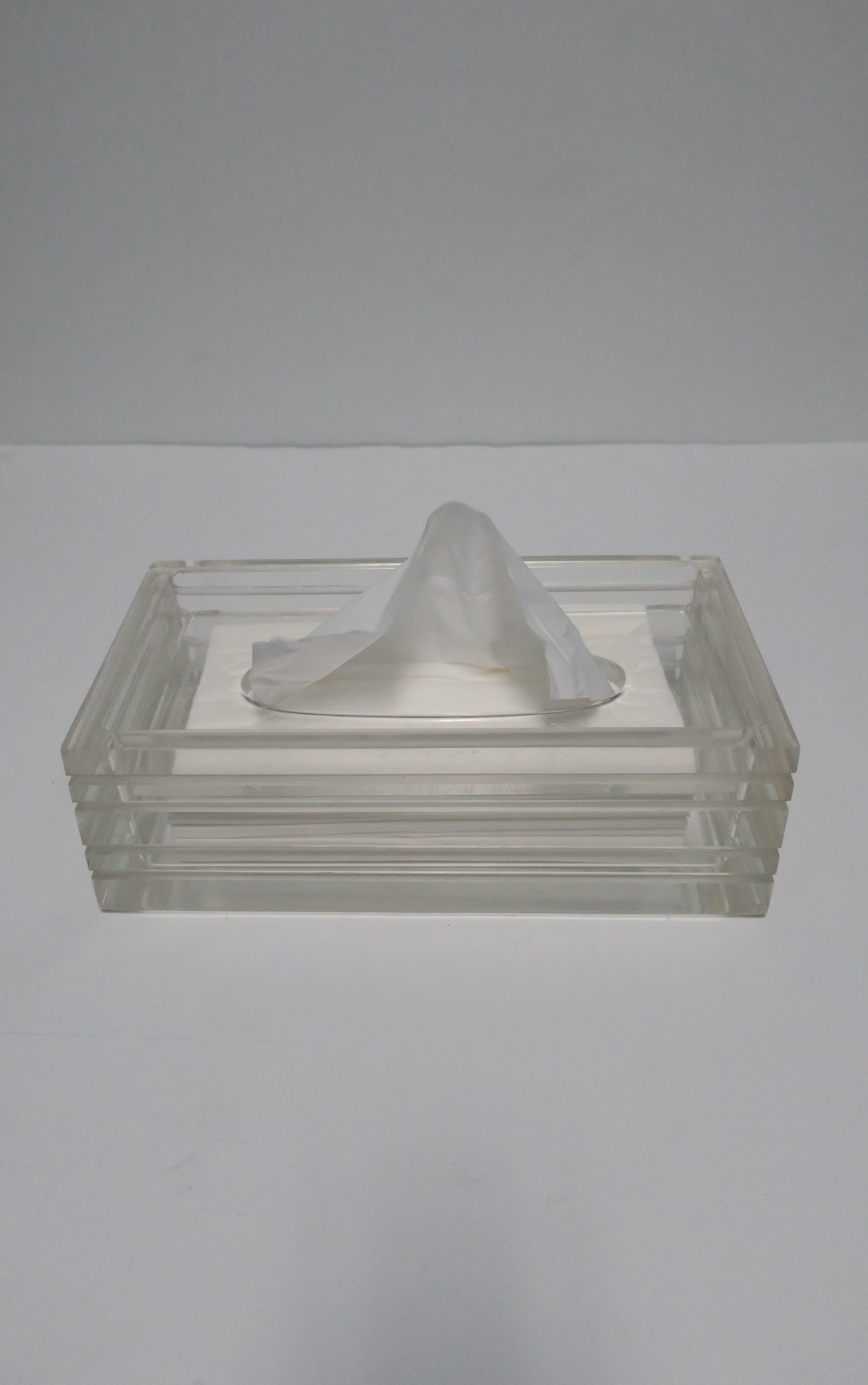 A beautiful and substantial vintage Modern Lucite tissue box in the style of American Designer, Charles Hollis Jones, circa 1970s or later. Substantial Lucite with horizontal indentation detail on all sides. 

