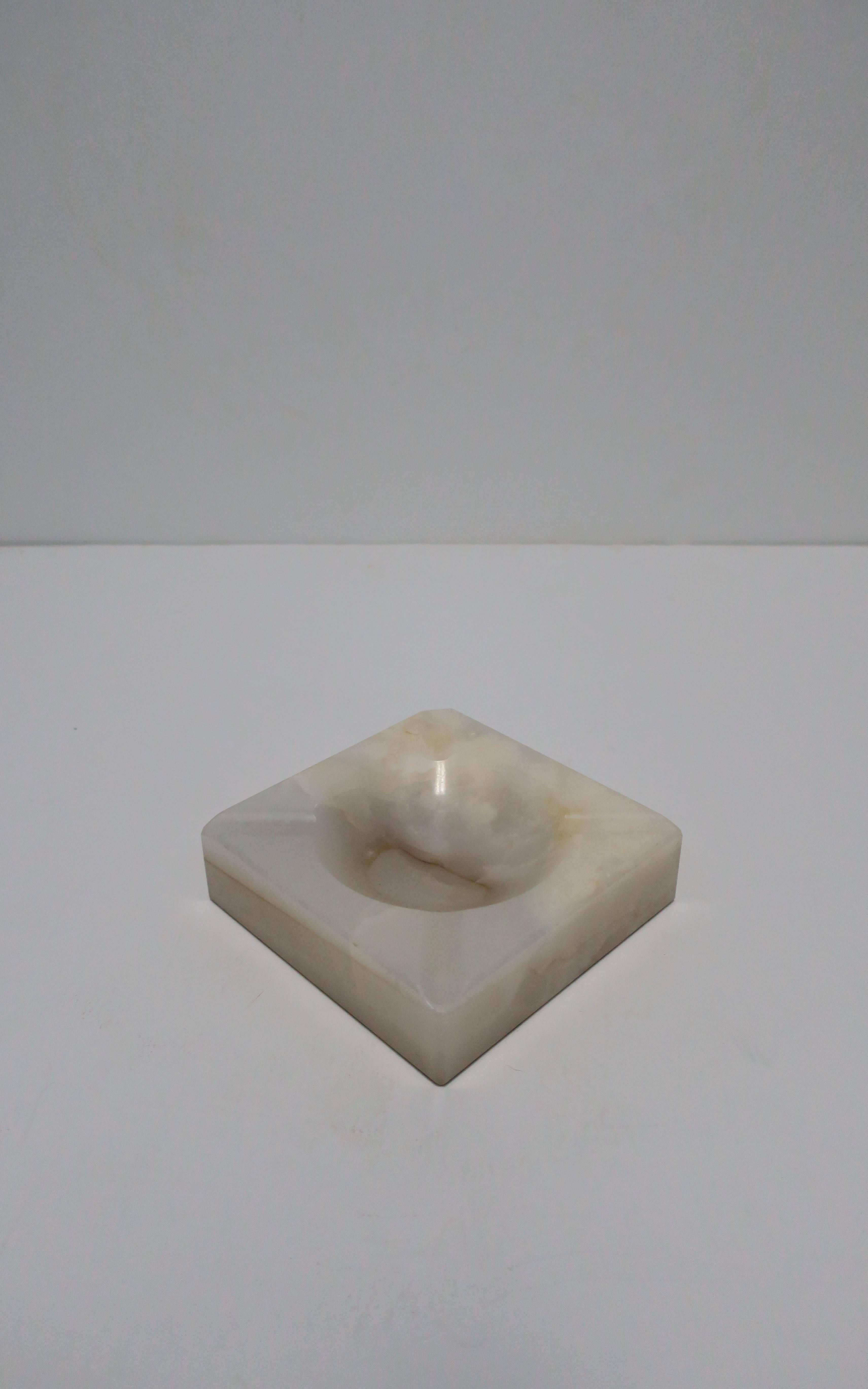 A beautiful vintage predominantly white, off-white and cream colored, onyx ashtray or vessel. Art Deco, circa 1940s. Onyx has natural veining throughout as show in images. Item available here online. By request, item can be made available by