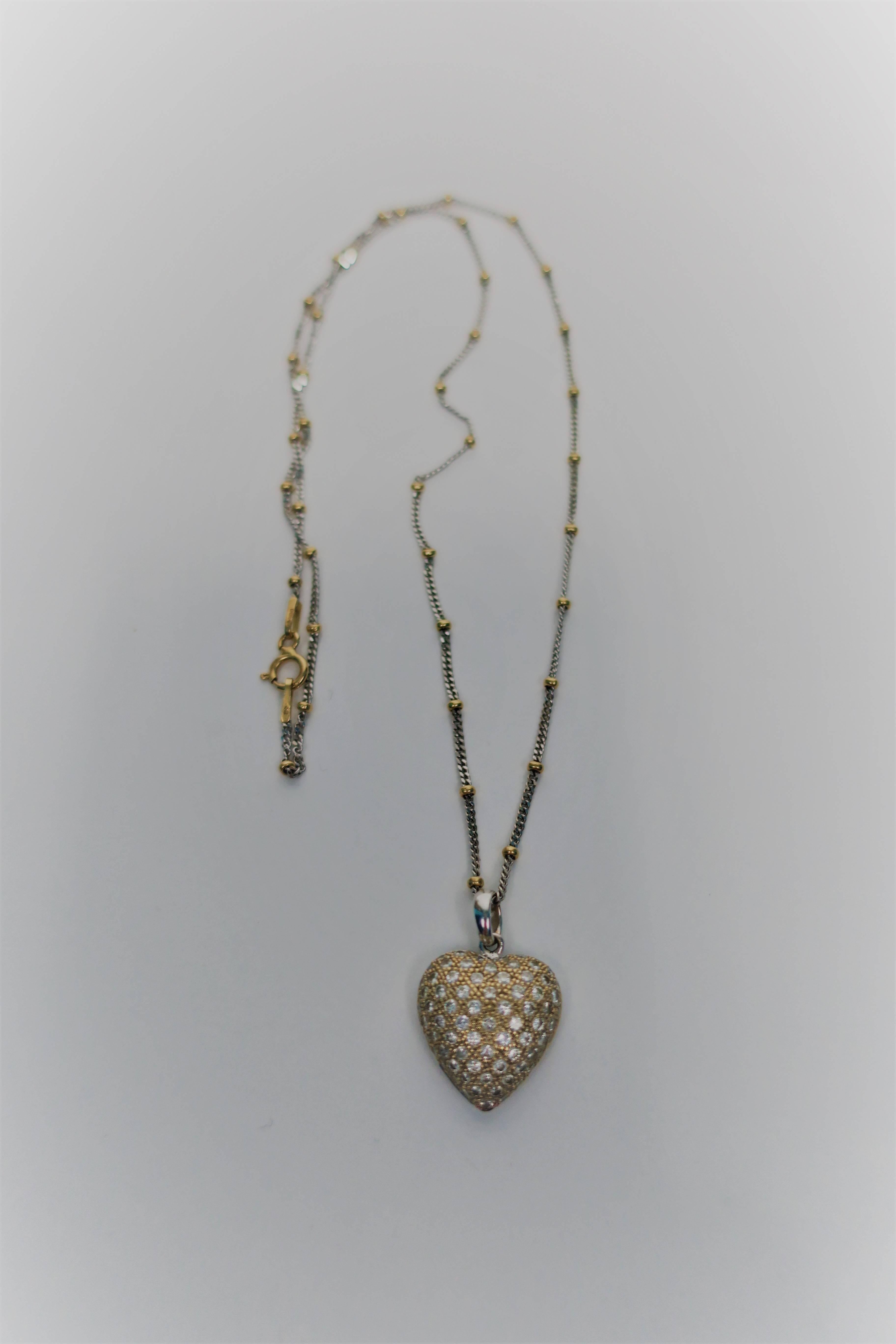A beautiful and sparkly Pave' diamond and 18-Karat yellow and white gold pendant heart with necklace, in the style of Cartier. Necklace is a beautiful combination of white and yellow 18-karat gold and measures: 17