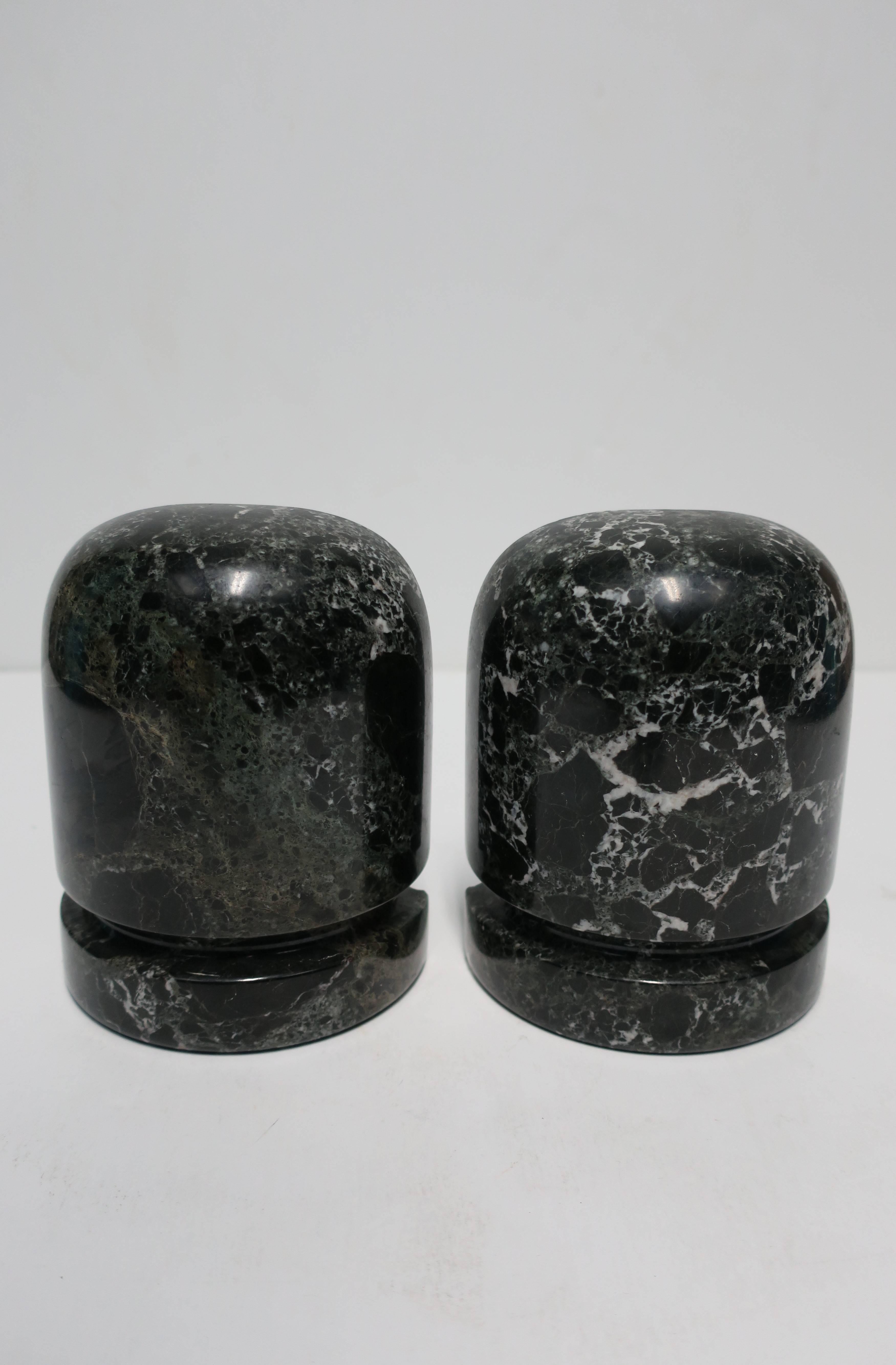 Pair/set available here for $450
A vintage pair of black and white marble bookends. Marble is polished smooth with carved detailed at base. 

Measurements: 6 in. H x 4.75 in. W x 2 3/8 in. D. 

Pair available here online. By request, pair can be